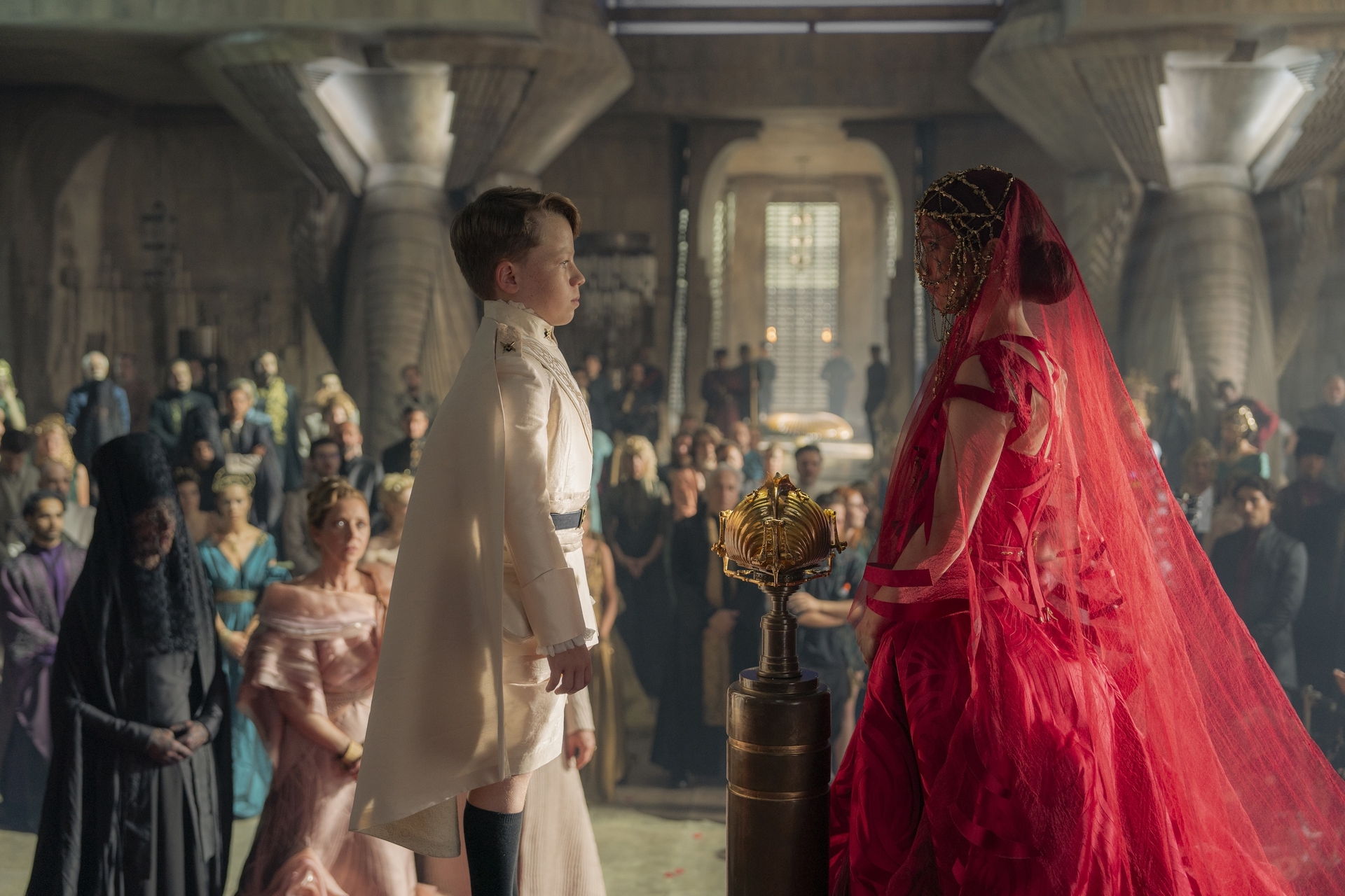 Princess Ynez (Sarah-Sofie Boussnina) stands in a dramatic gown as she meets her betrothed for the first time in a ceremony during Dune: Prophecy’s pilot