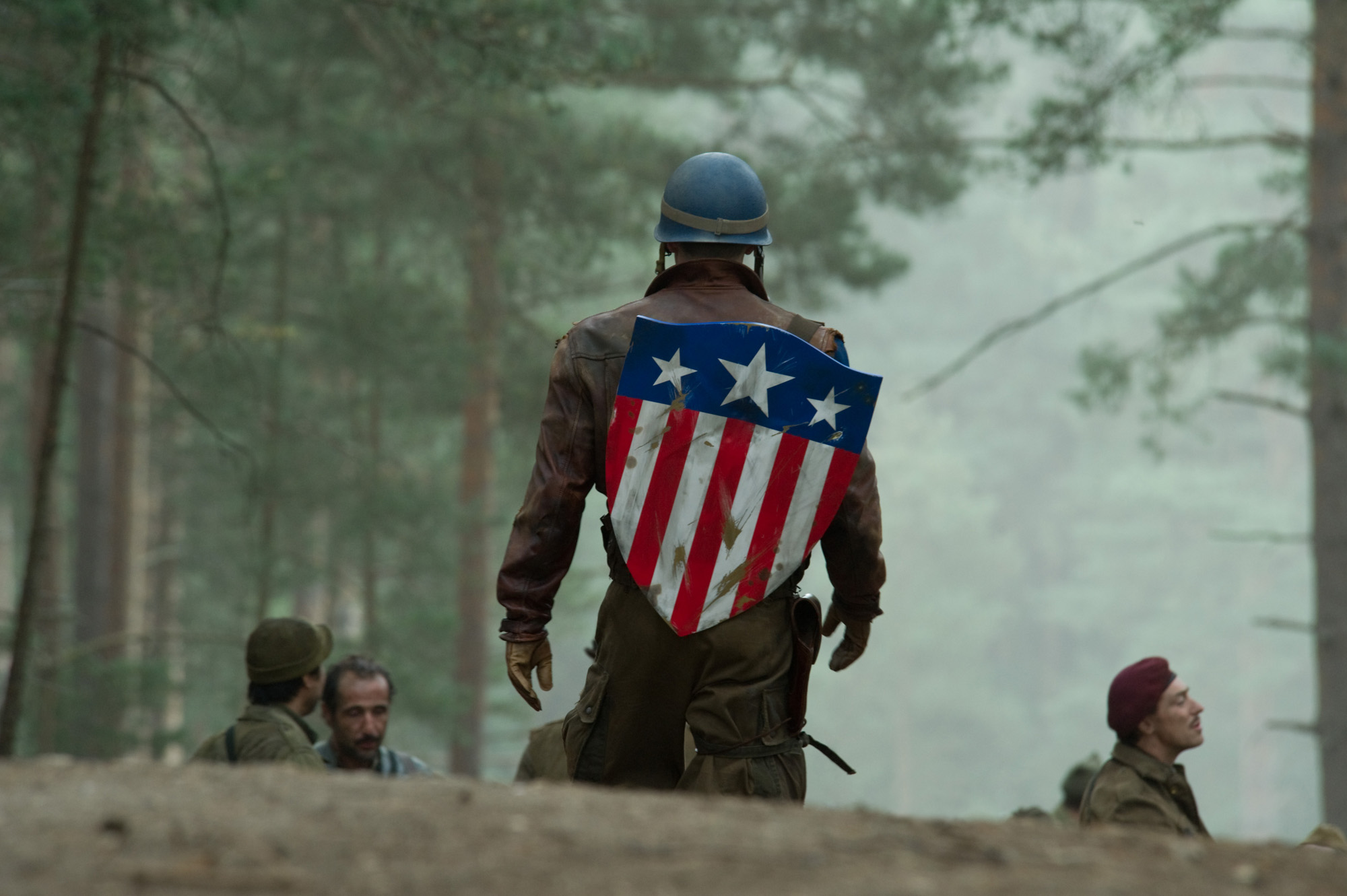 Steve Rodgers walks away from the camera, with his shield on his back