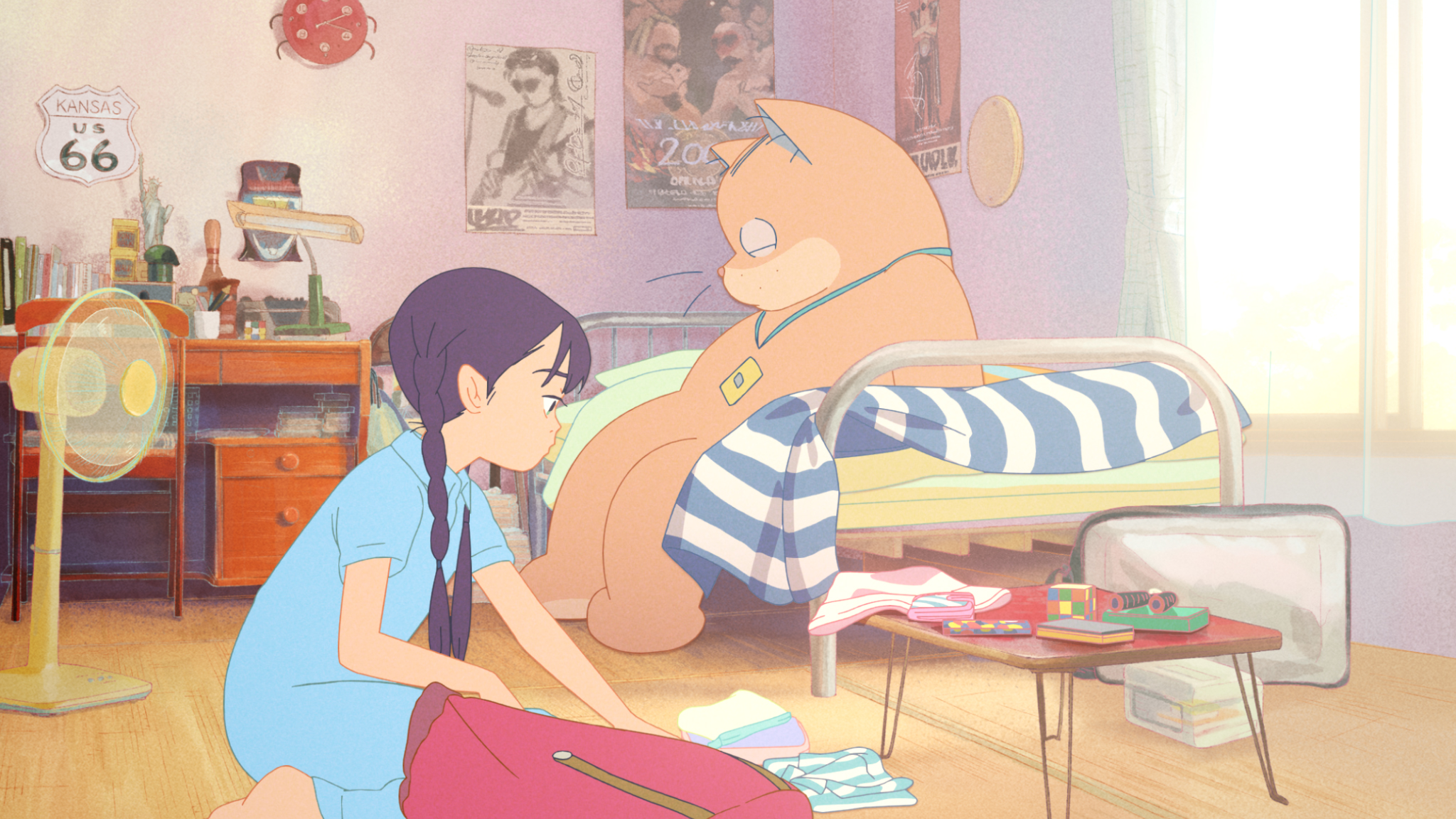 Purple-haired 11-year-old anime character Karin packs a bag, while Anzu, a giant orange cat, sits on a bed behind her in Ghost Cat Anzu