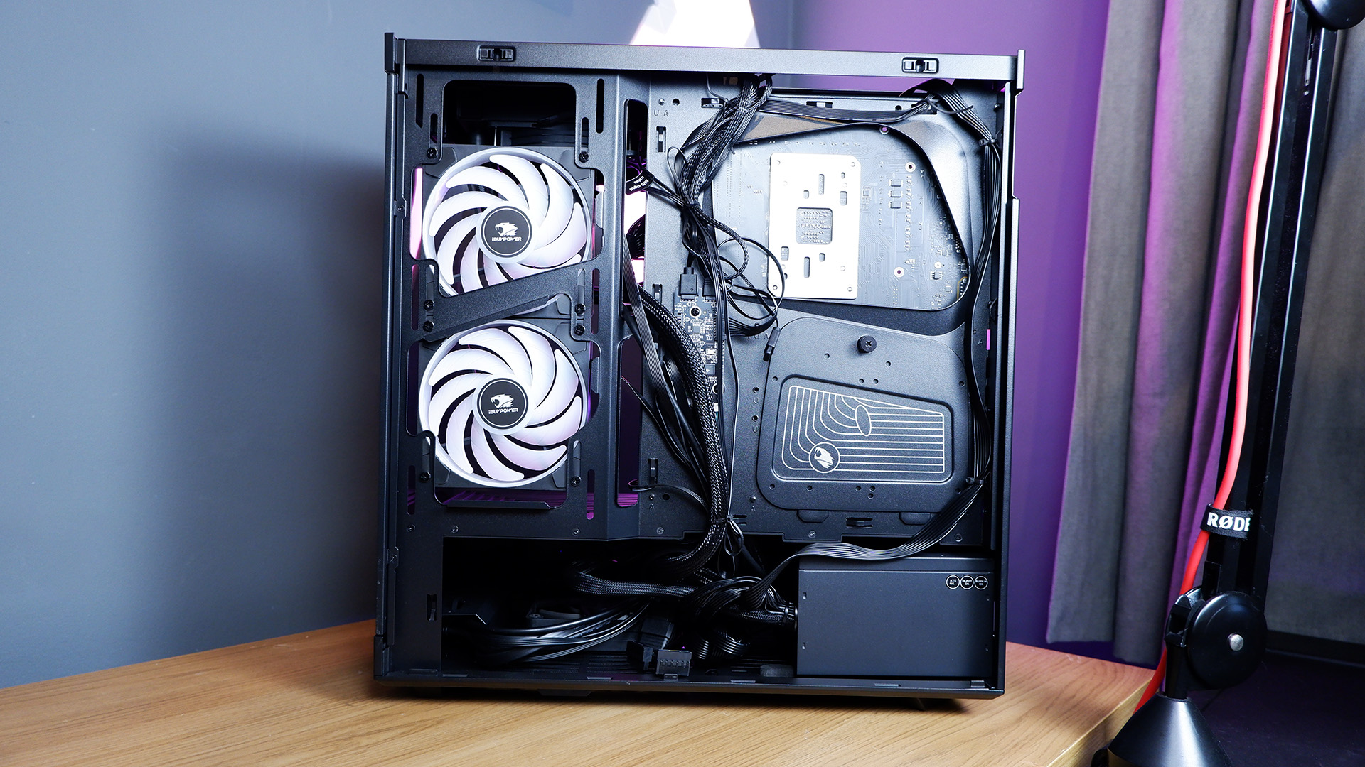 An iBuyPower gaming PC being set up on a desktop.