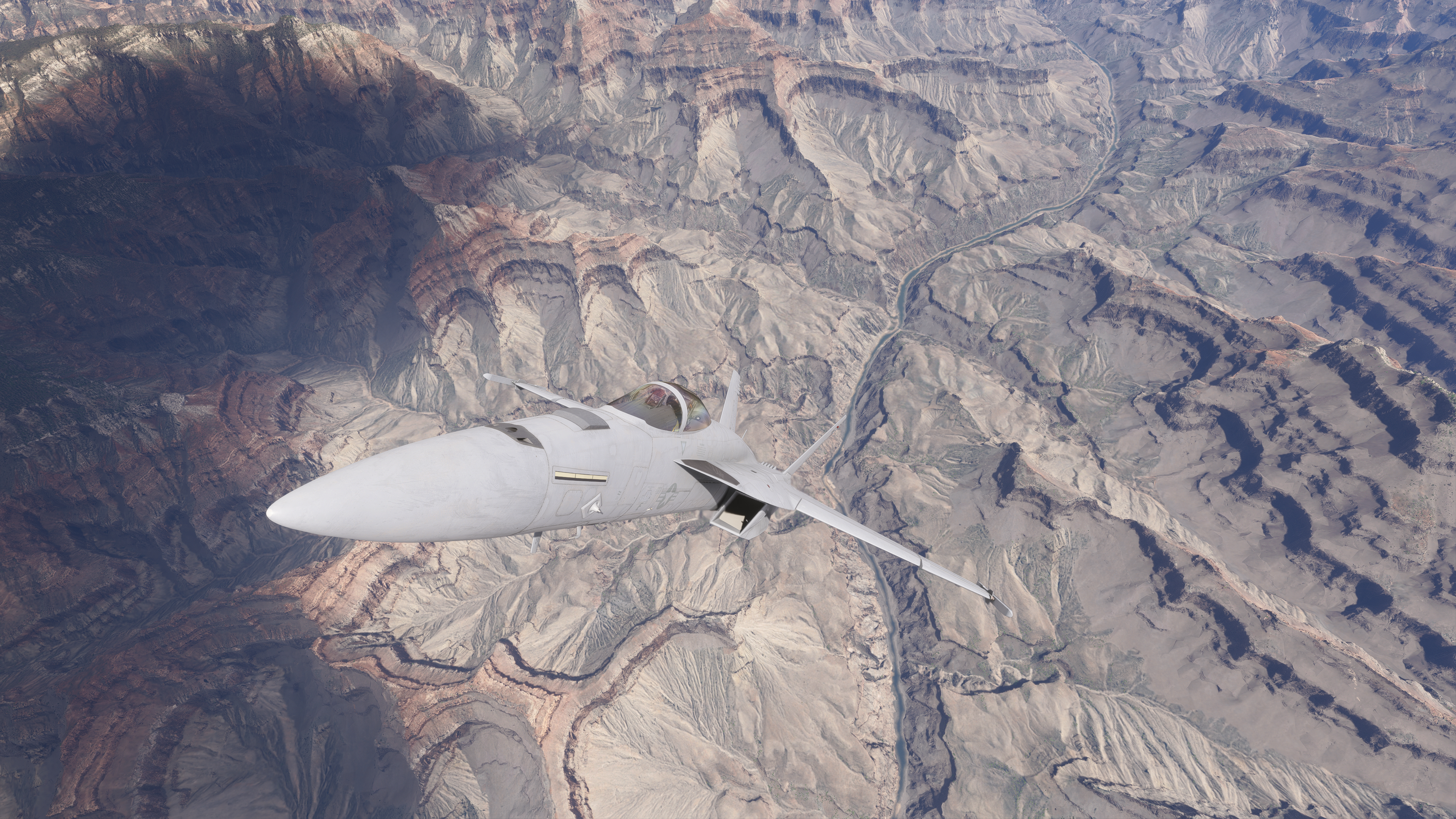 An military jet flying over the grand canyon