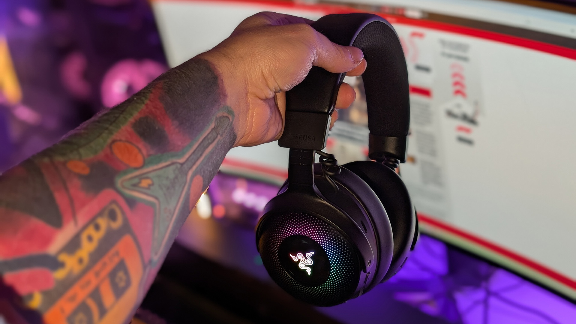 Razer Kraken V4 Pro gaming headset on a desk and with RGB enabled.