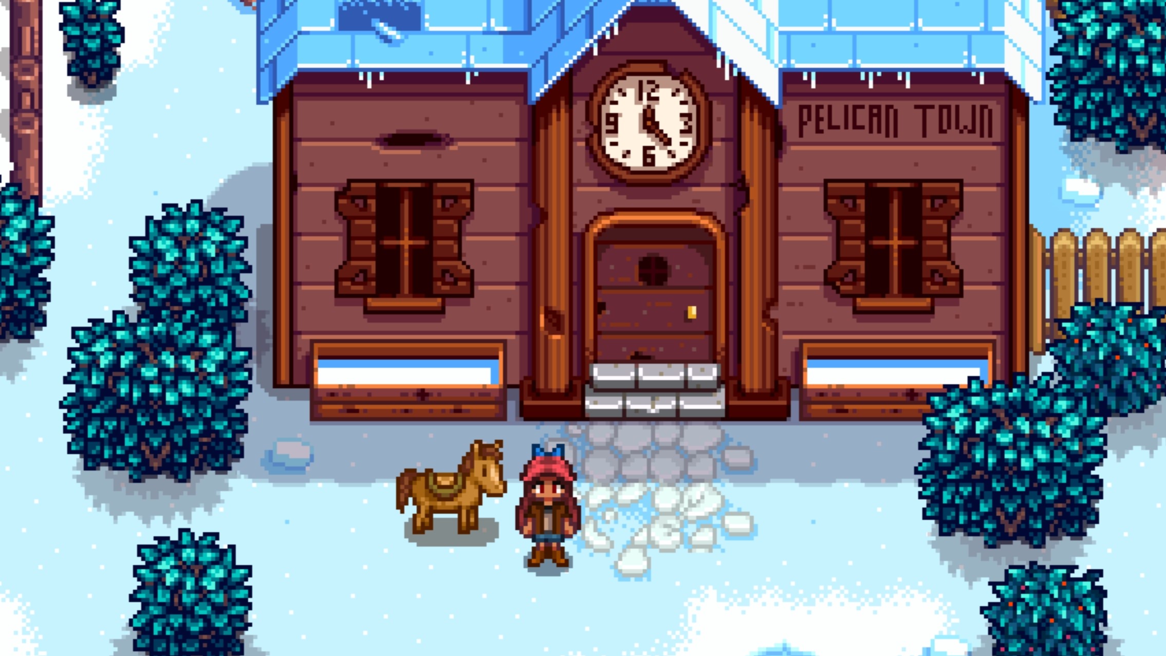 A Stardew Valley farmer standing outside the Community Center during Winter, to her left is her Horse.