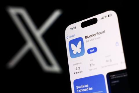 X logo displayed on a laptop screen and Bluesky Social on App Store displayed on a phone screen are seen in this illustration photo taken in Poland on November 16, 2024.