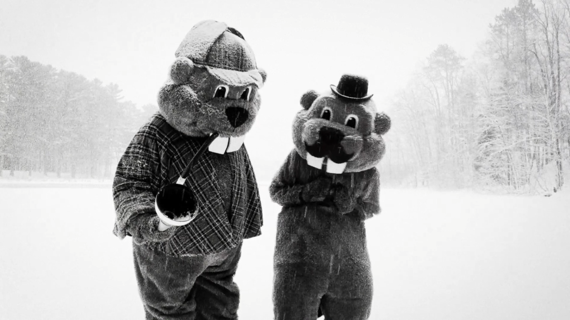 Two people in mascot-sized beaver costumes wear a Sherlock and Watson outfit in the snow in Hundreds of Beavers