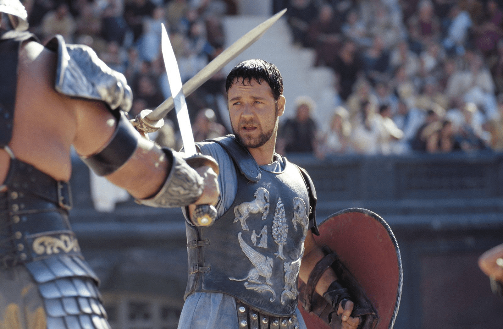 Russell Crowe crossing swords with another gladiator in Gladiator.