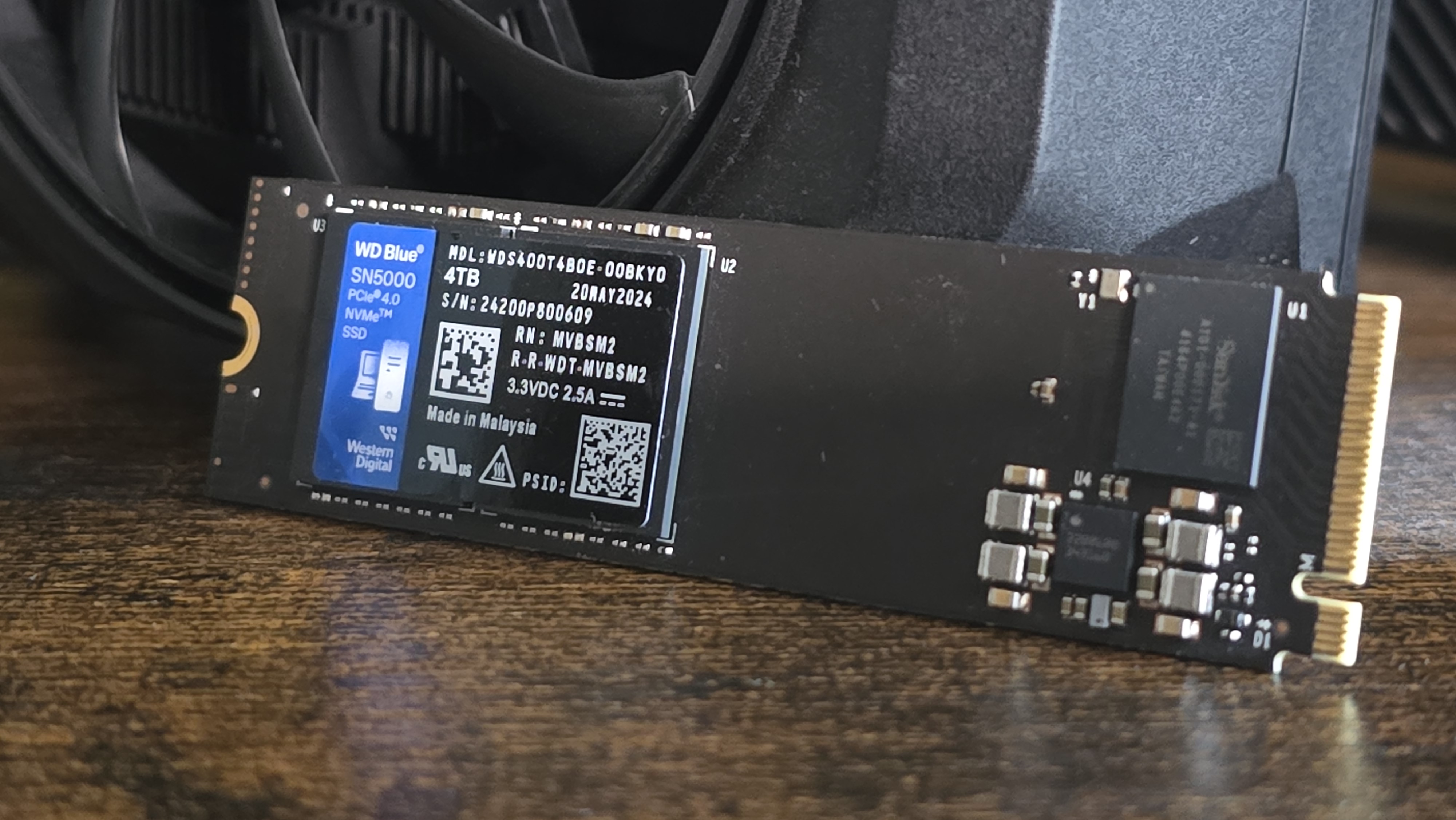 A WD SN5000 SSD out of its box and installed in a PC's NVMe slot.