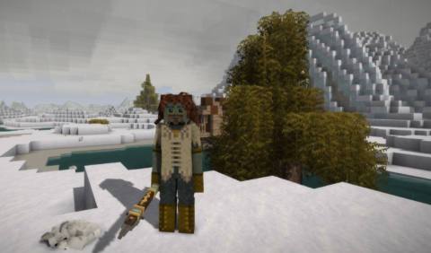 A man with a spear standing in the snow in front of a mountain in a blocky voxel game