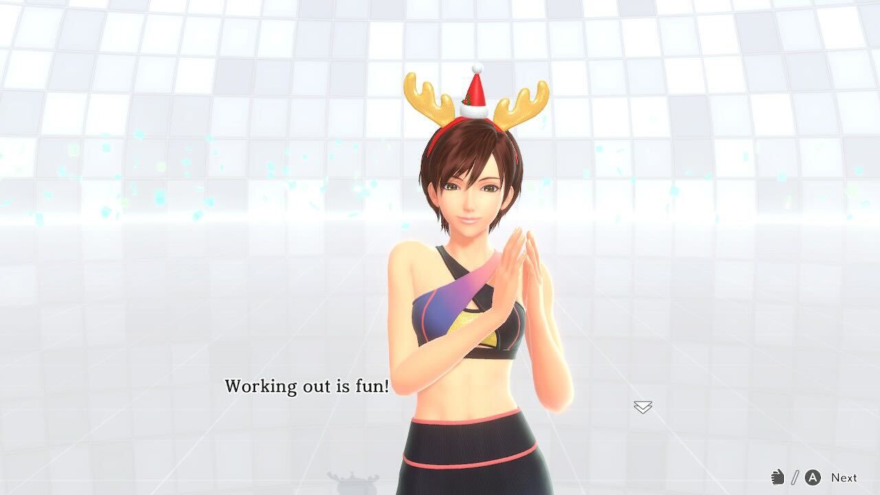 One of the trainers from Fitness Boxing 3, wearing a pair of reindeer horns in headband form, saying, “Working out is fun!”