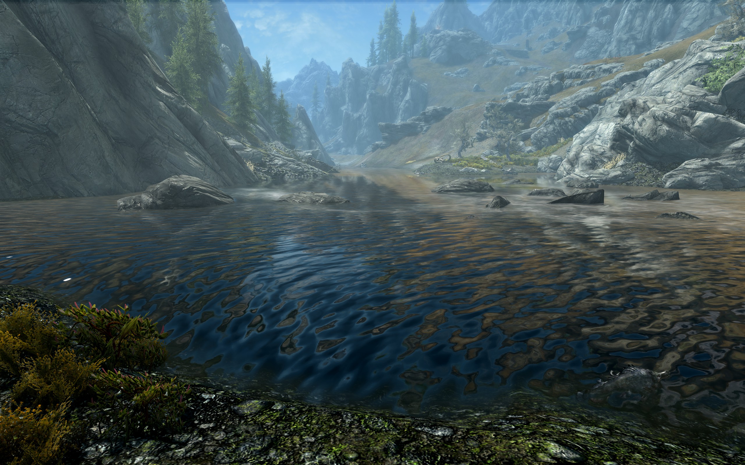 A lake with mountains in the distance