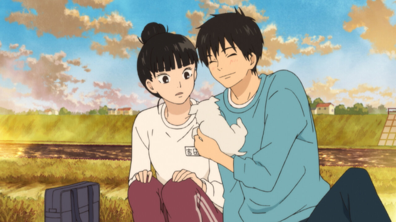 An anime girl and boy holding a small puppy in Kimi ni Todoke: From Me to You.