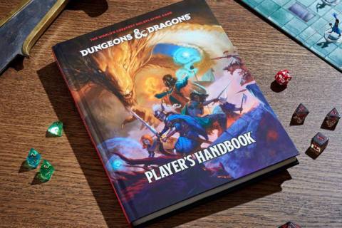 A copy of the 2024 Dungeons & Dragons Players Handbook on a table surrounded by various dice