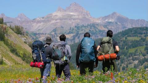 Four hikers face Grand Teton in an episode of Adventure Archives.