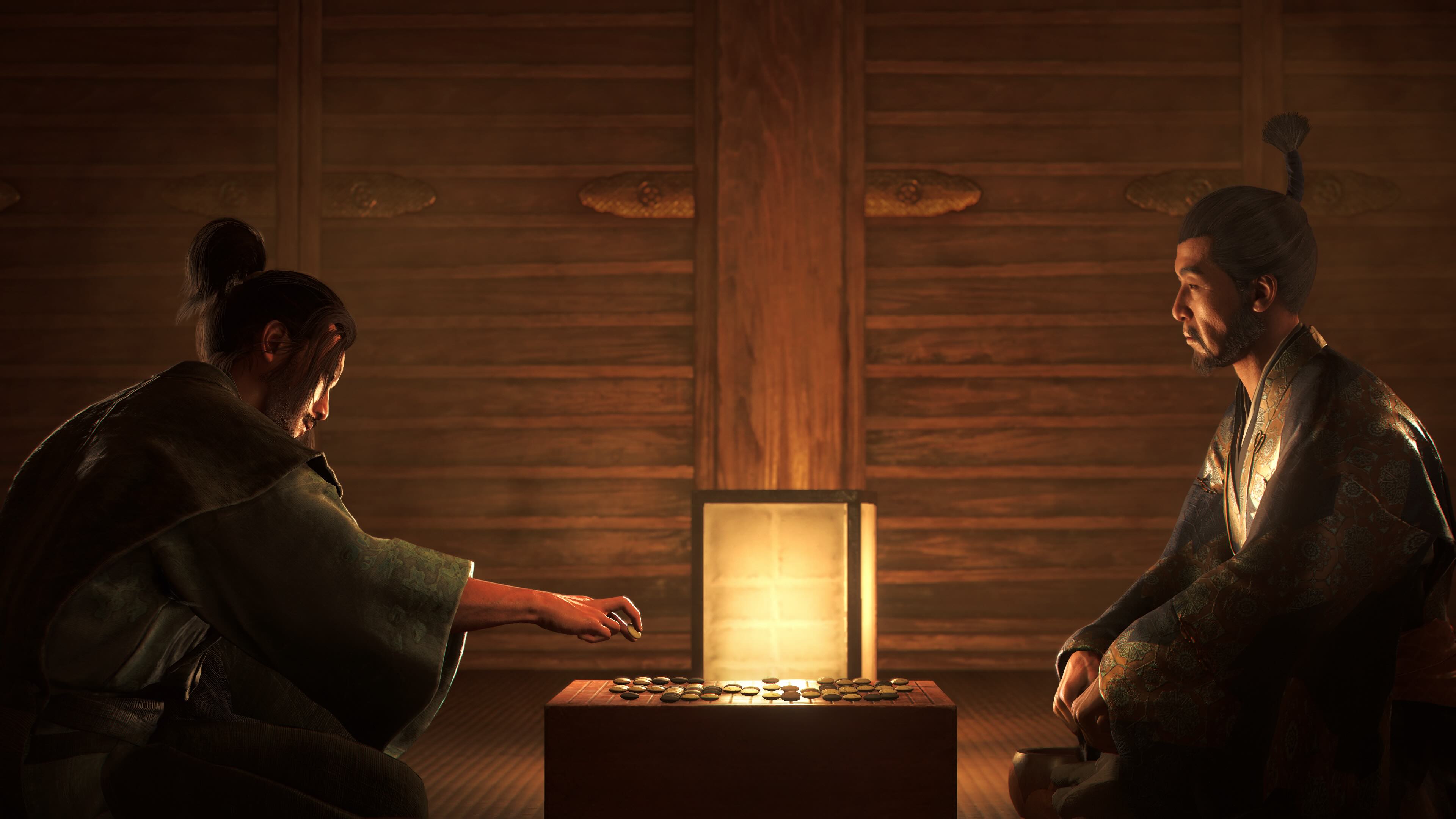 Two characters sit at a small table in a dimly lit room in Assassin’s Creed Shadows Two characters sit at a small table in a dimly lit room in Assassin’s Creed Shadows