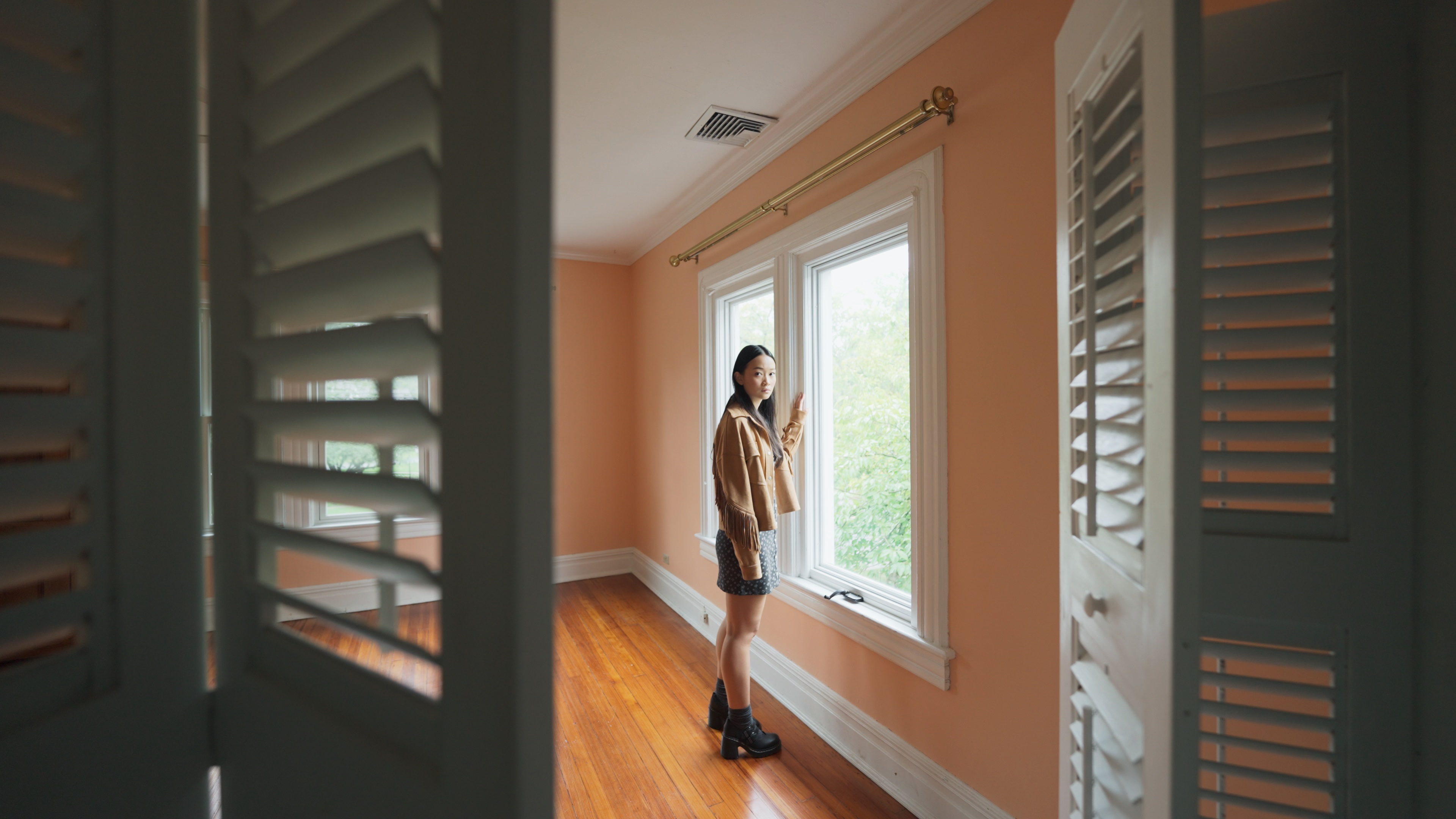 Chloe (Callina Liang), a forlorn-looking teenager, stands by a window in an unfurnished room and looks at the closet, where an unseen presence lurks in Presence Chloe (Callina Liang), a forlorn-looking teenager, stands by a window in an unfurnished room and looks at the closet, where an unseen presence lurks in Presence