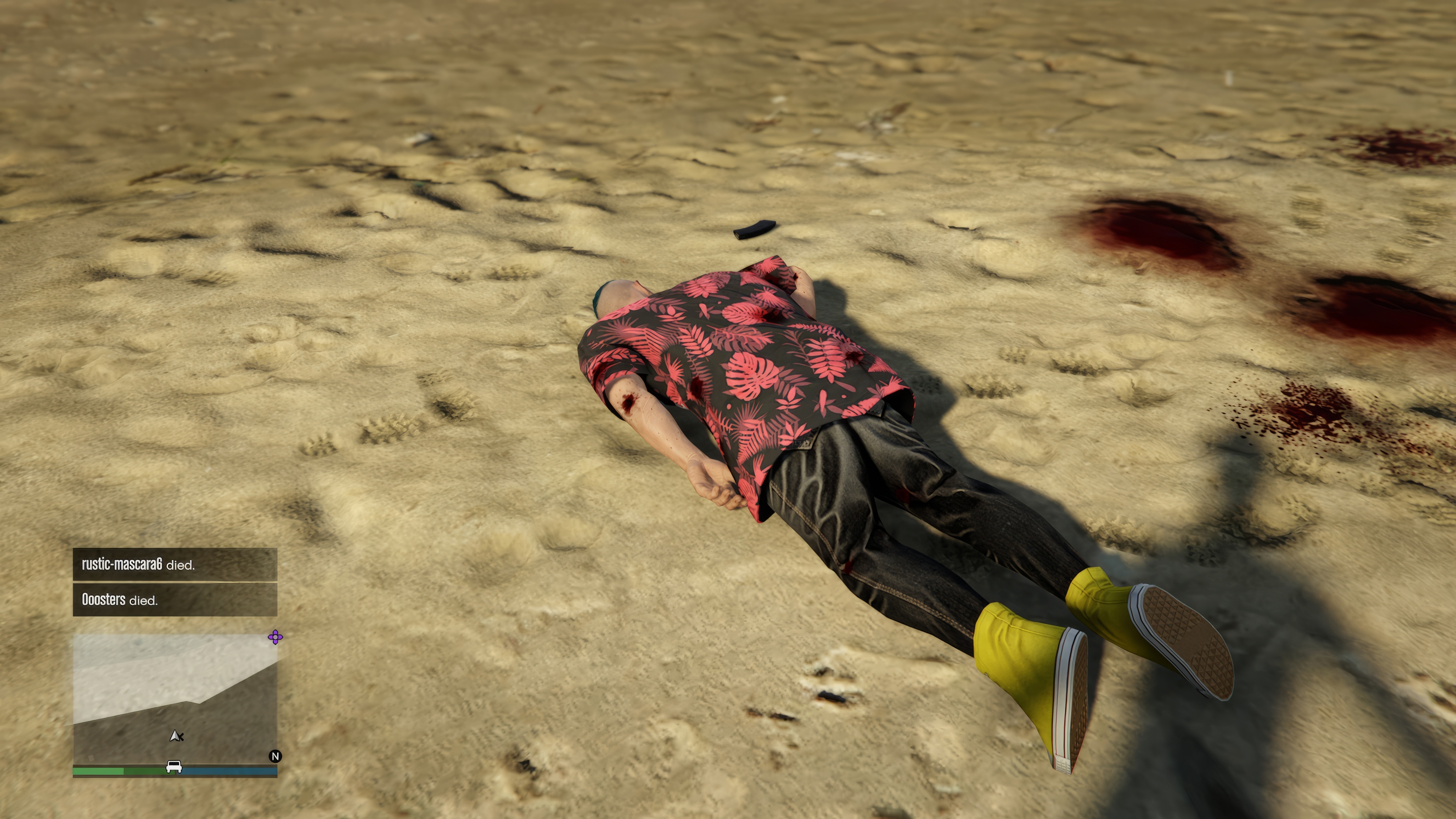 An avatar in a patterned red shirt and yellow high-top tennis shows lies face-down on the ground with blood spattered around the area and a human shadow looming over him in Grand Theft Auto Online, in a scene from Grand Theft Hamlet An avatar in a patterned red shirt and yellow high-top tennis shows lies face-down on the ground with blood spattered around the area and a human shadow looming over him in Grand Theft Auto Online, in a scene from Grand Theft Hamlet