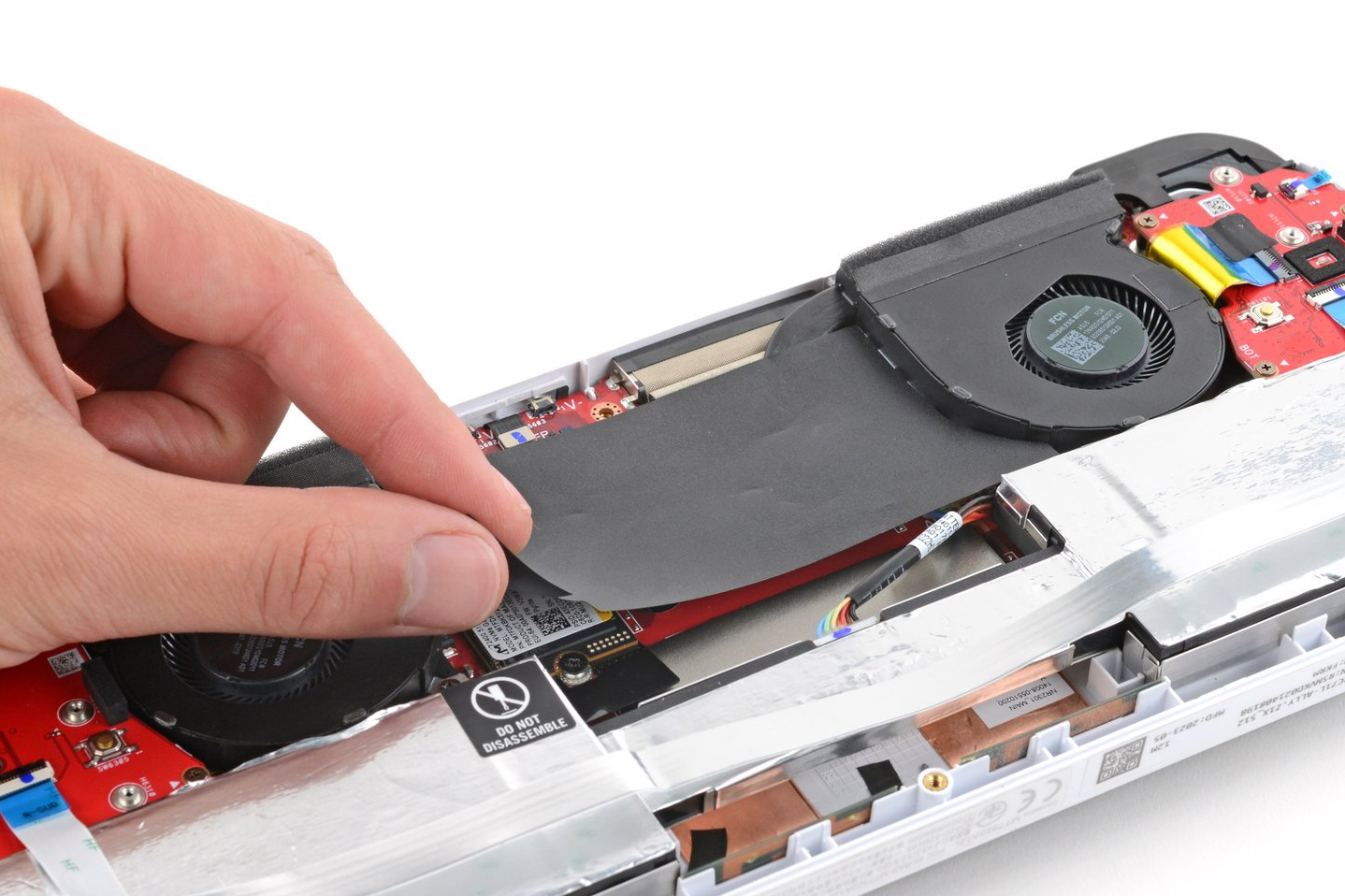 A photo of a hand removing the plastic covering the internal components of the ROG Ally A photo of a hand removing the plastic covering the internal components of the ROG Ally