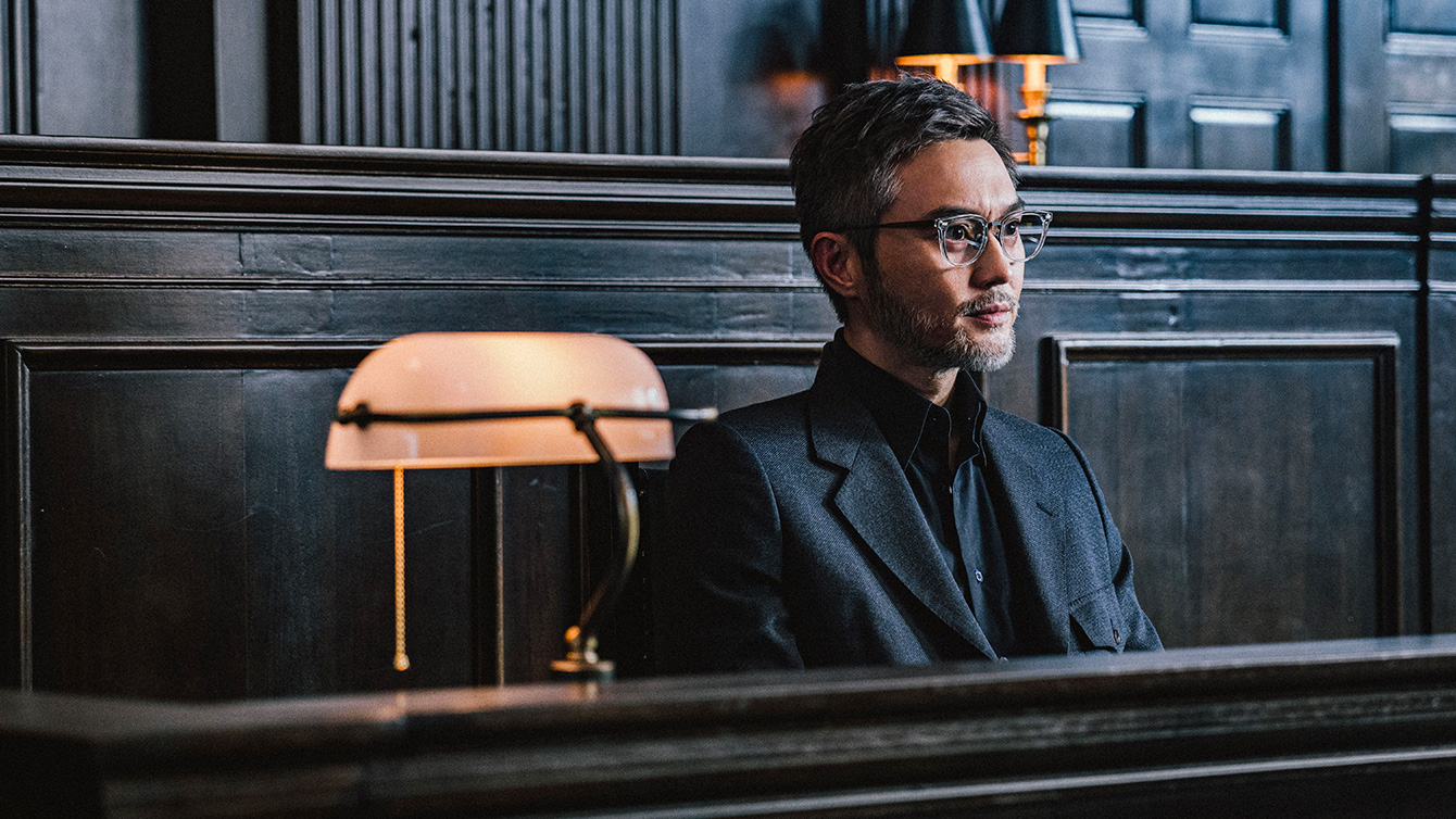 A smartly dressed man with glasses and salt and pepper facial hair testifies in court in The Prosecutor A smartly dressed man with glasses and salt and pepper facial hair testifies in court in The Prosecutor