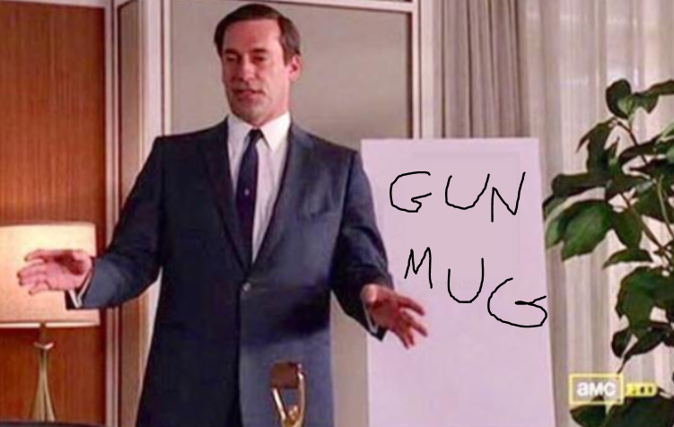 Don Draper in front of a whiteboard that says GUN MUG on it