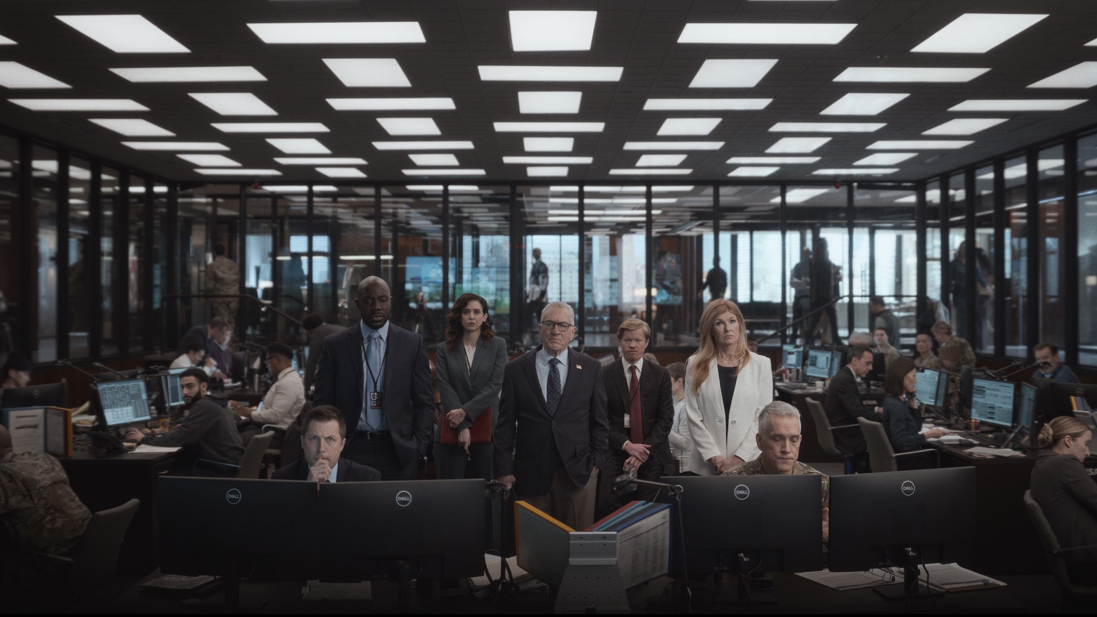 Robert De Niro and the rest of the cast of Zero Day standing in a large office building 
