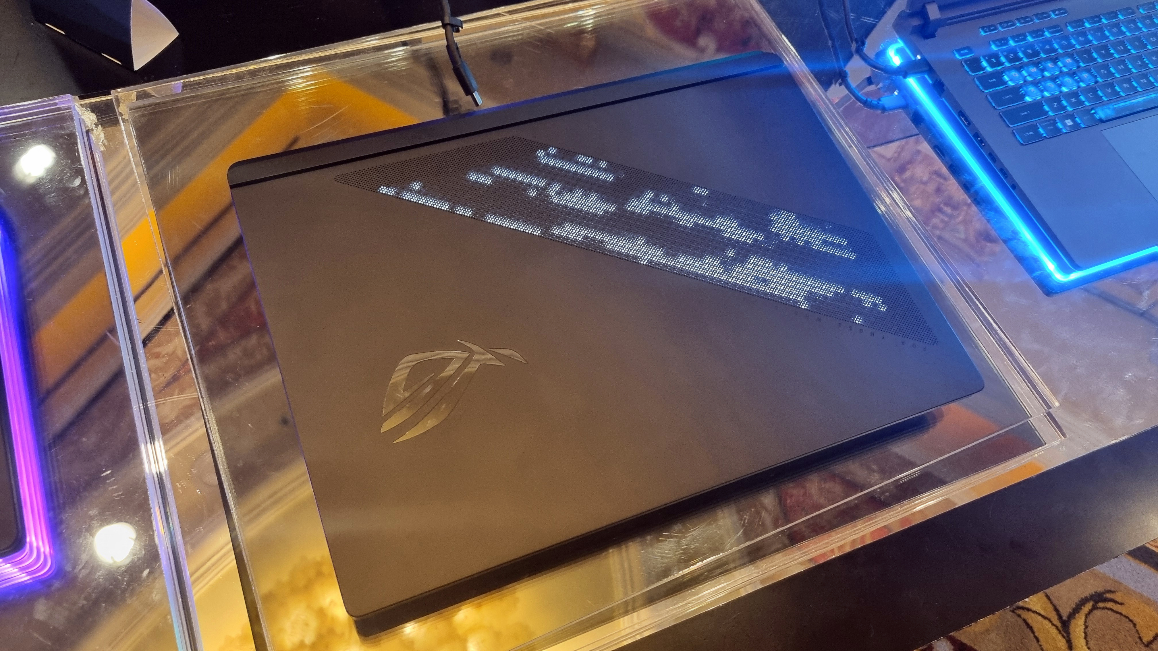 The outer lid of the Asus ROG Strix Scar 18, showing the LEDs lit.