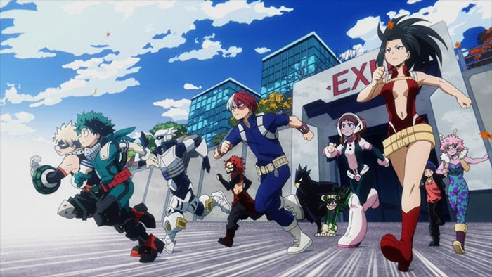 A group of costumed heroes, led by series protagonists Izuku “Deku” Midoriya and Katsuki Bakugo, racing out of a gate marked “Exit” to participated in a hero training exercise. A group of costumed heroes, led by series protagonists Izuku “Deku” Midoriya and Katsuki Bakugo, racing out of a gate marked “Exit” to participated in a hero training exercise.
