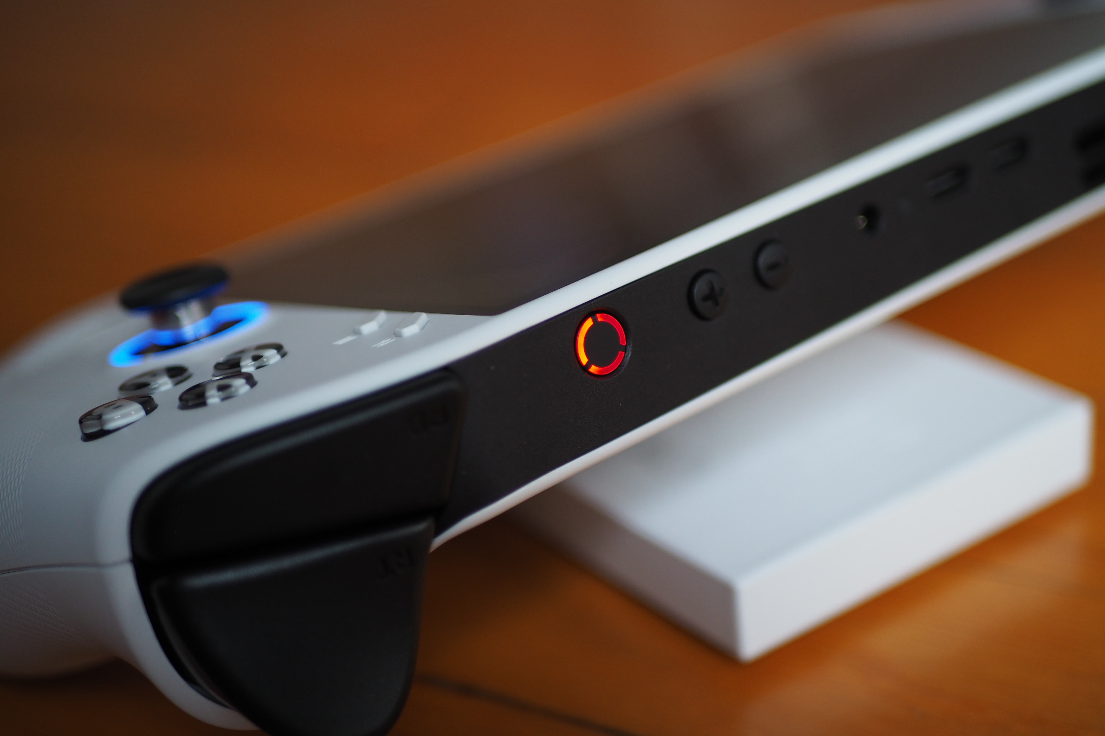 An image showing the top side of the Lenovo Legion Go S handheld as it rests on a wooden surface. An image showing the top side of the Lenovo Legion Go S handheld as it rests on a wooden surface.