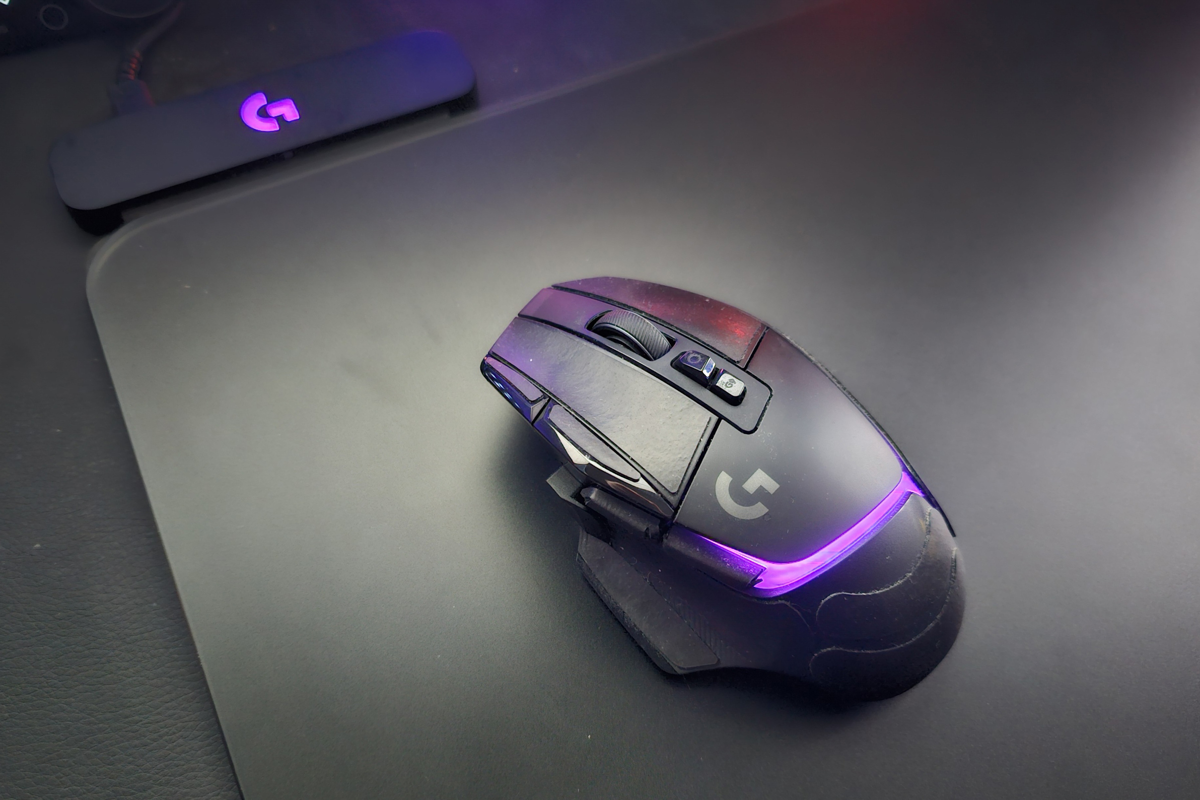 A photo of the Logitech G502 X Plus being used on top of the original Powerplay mouse pad