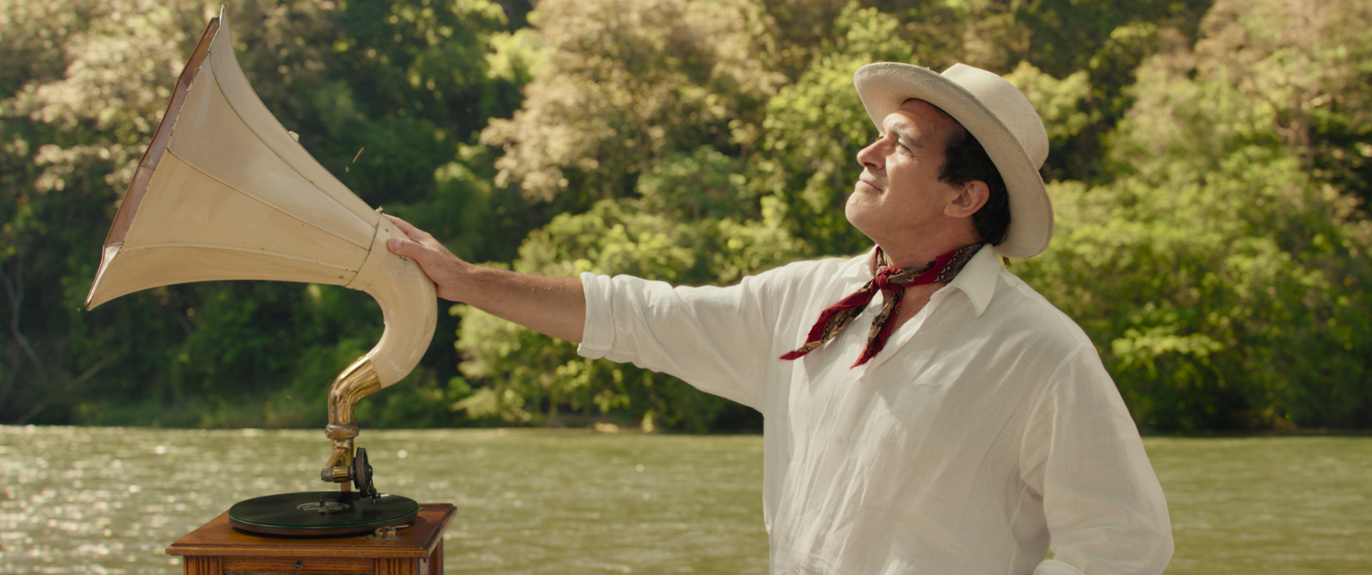 Antonio Banderas as a riverboat captain, one hand on a phonograph, as he squints into the sunlight from Paddington in Peru Antonio Banderas as a riverboat captain, one hand on a phonograph, as he squints into the sunlight from Paddington in Peru
