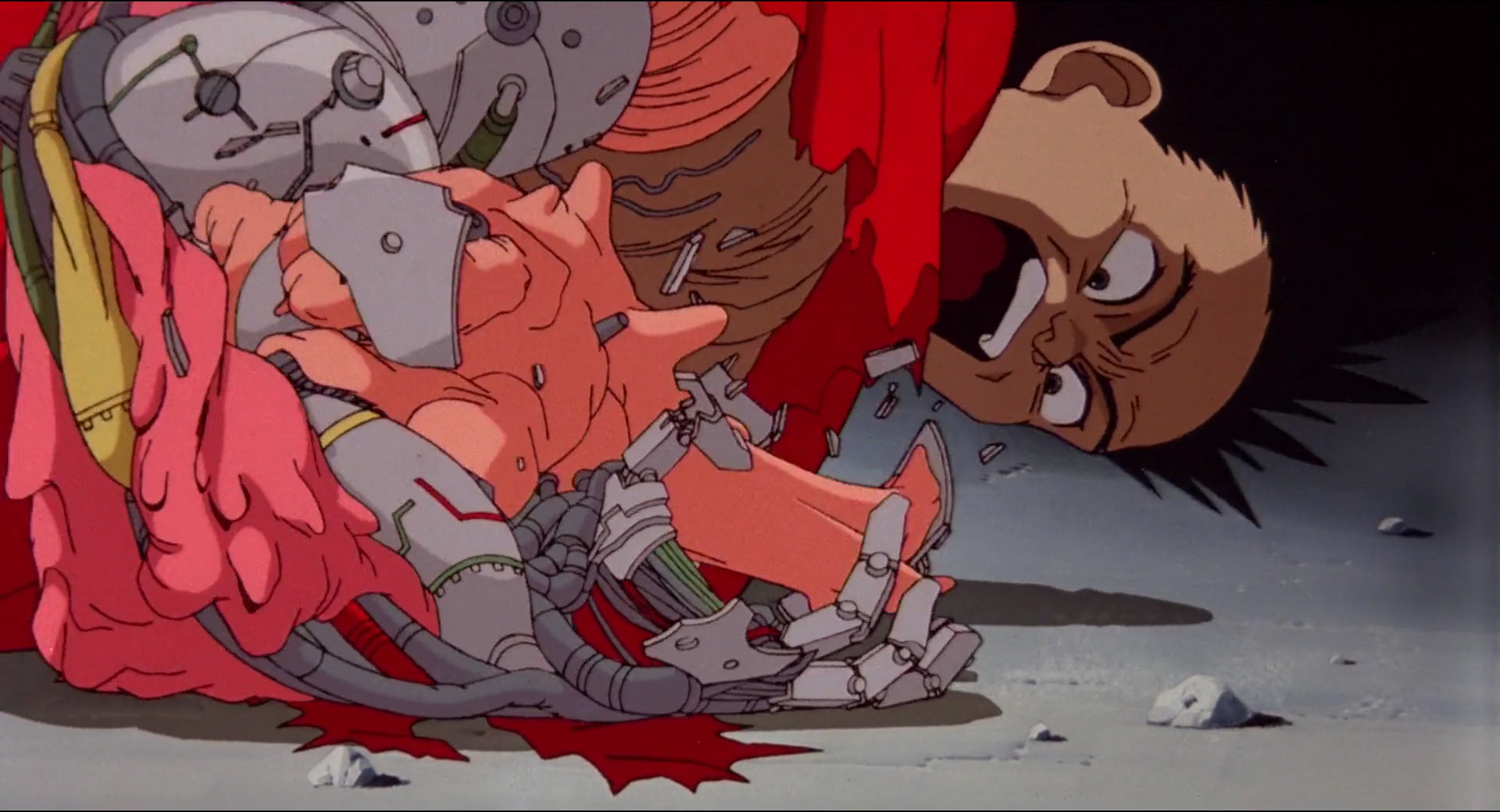 A black haired anime boy screaming as their arm is transformed into a blob of flesh and metal in Akira. A black haired anime boy screaming as their arm is transformed into a blob of flesh and metal in Akira.