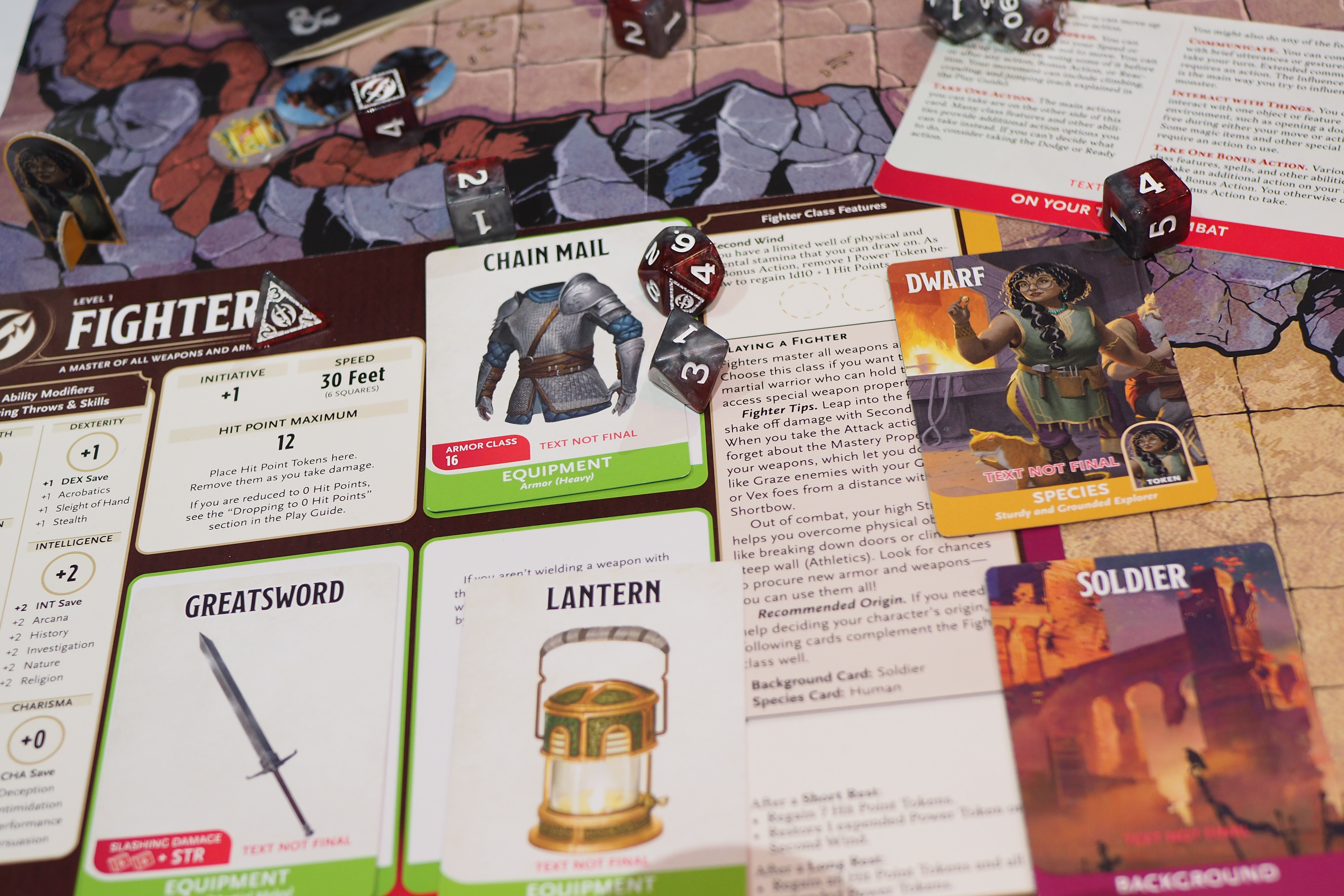 An image showing a top-down view of the 2025 Dungeons & Dragons Starter Set, focusing on a Fighter class character. The image shows multiple cards and game pieces that embellish the