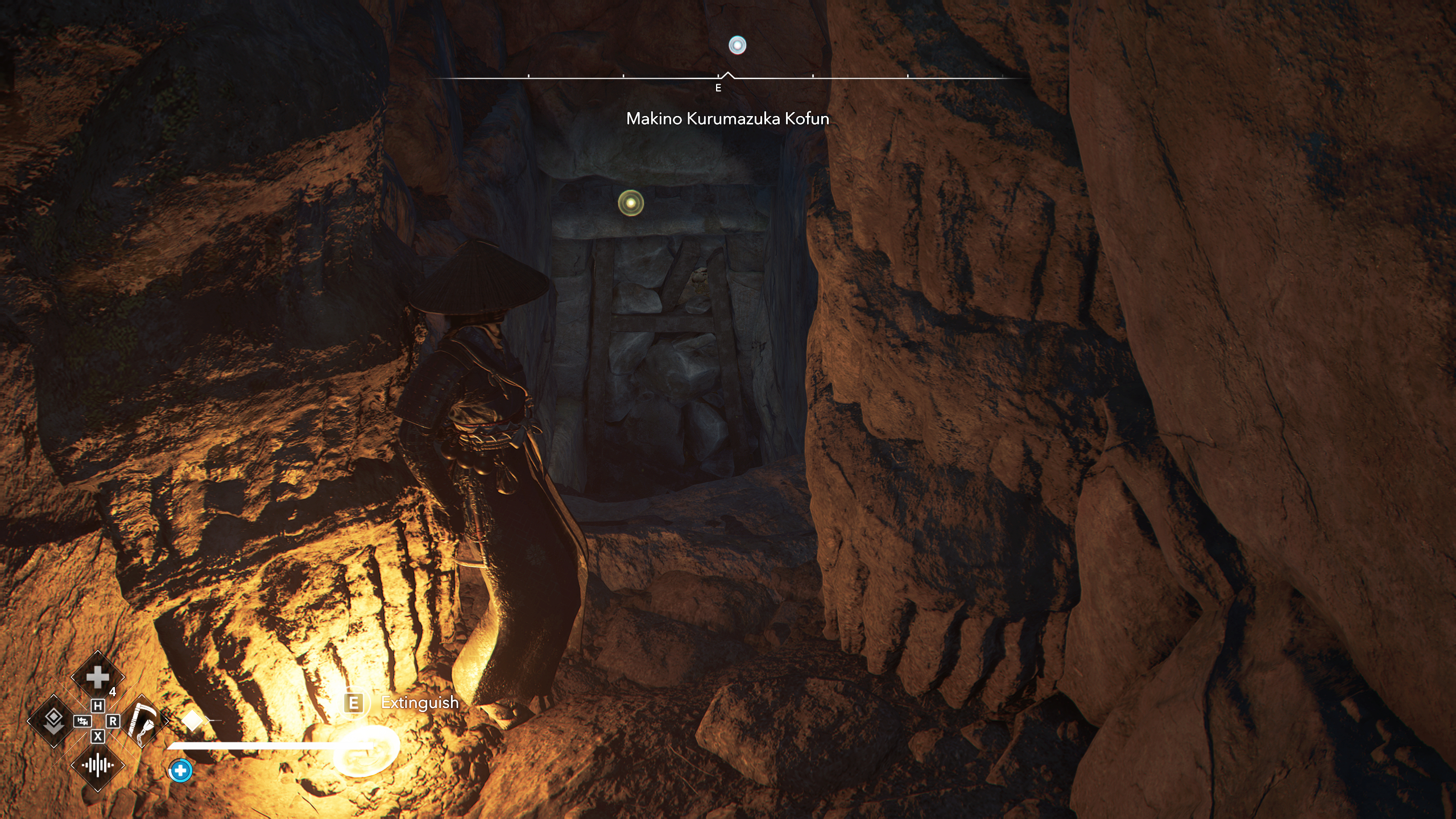 Assassin's Creed Shadows Makino Kurumazuka Kofun - Naoe tucked into the cave wall, revealing a blocked doorway at the bottom of the stairs.