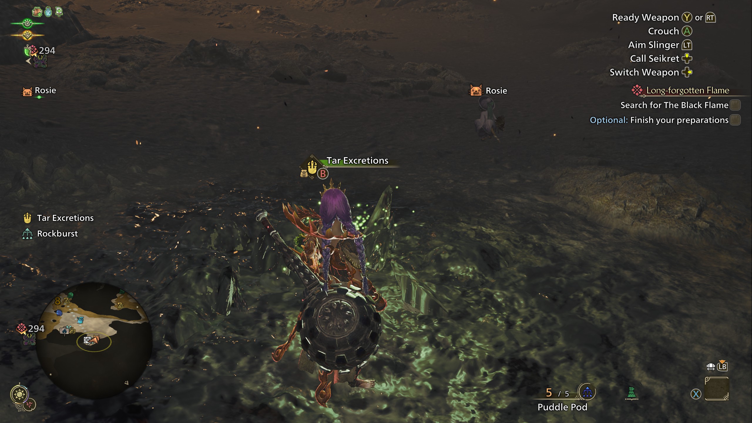 A woman in fiery armor stands over a pile of black goop. The menu above it says “tar excretions.” with an option to hit the B button. A woman in fiery armor stands over a pile of black goop. The menu above it says “tar excretions.” with an option to hit the B button.