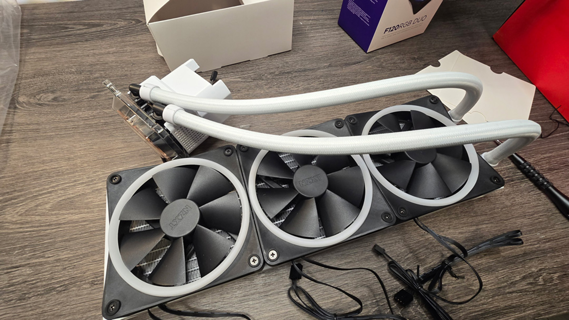 Various steps to building a gaming PC, including installing a liquid cooler.