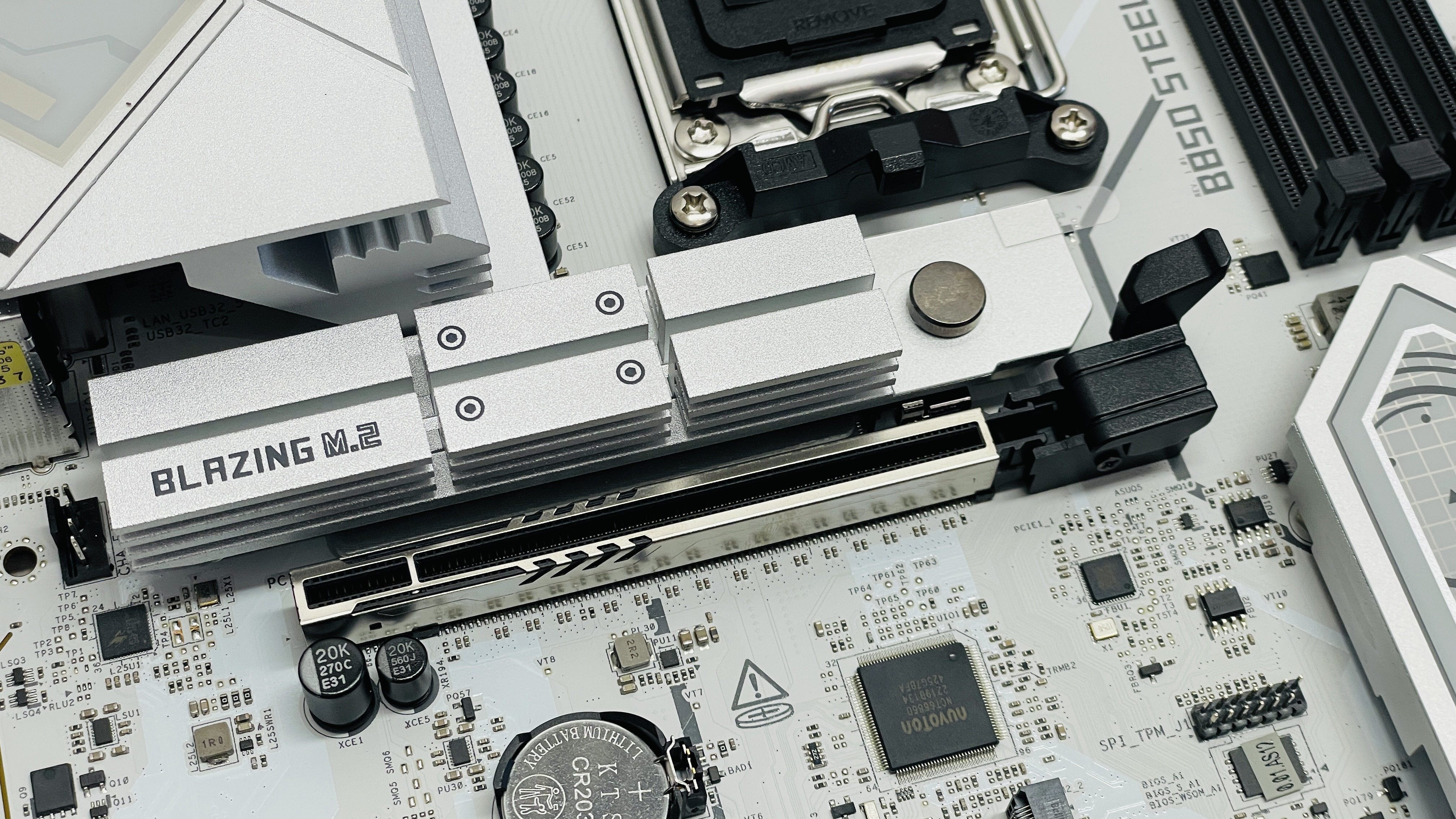 ASRock B850 Steel Legend Wi-Fi motherboard on a desk.