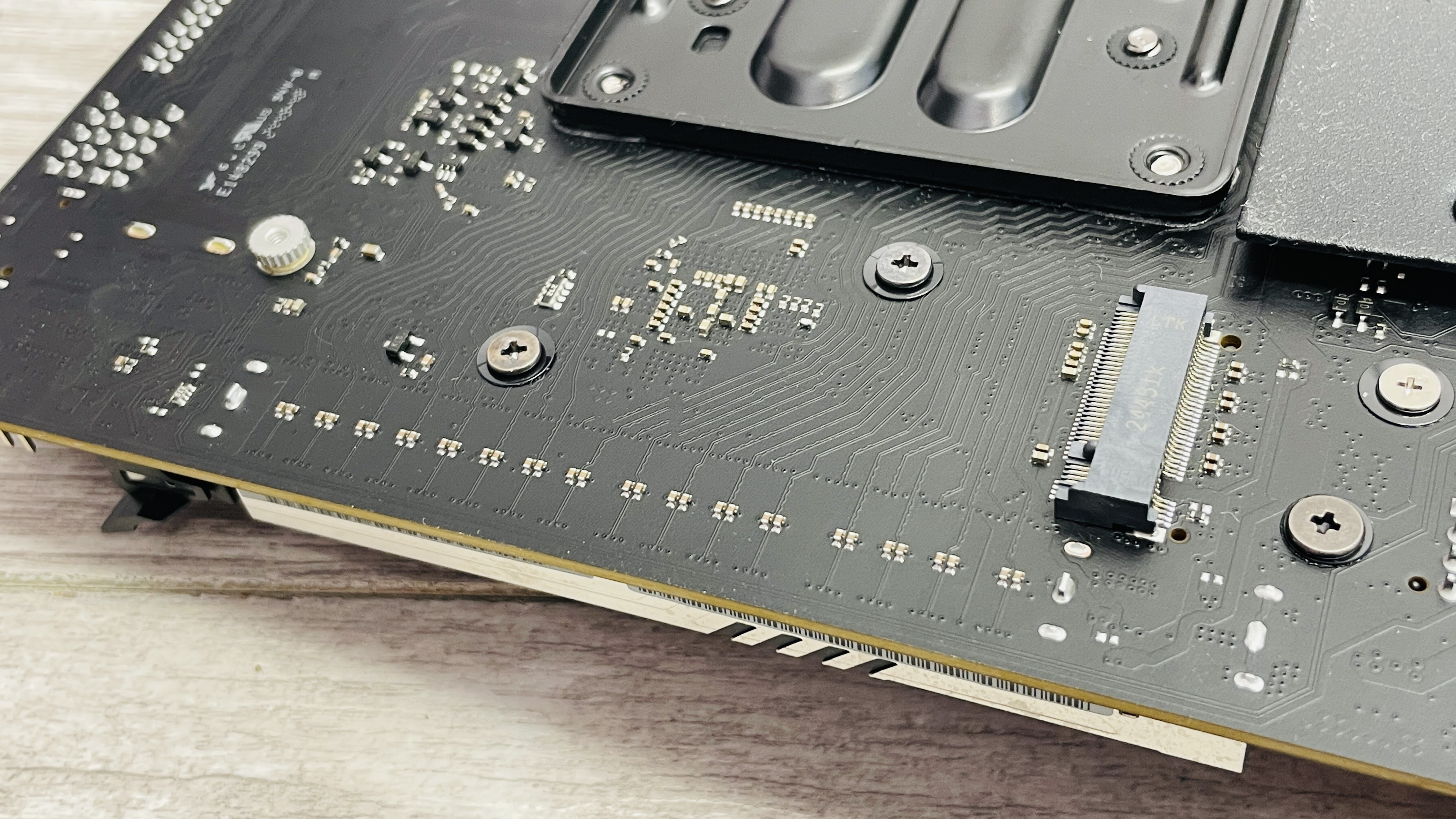 ASRock Phantom Gaming B850I Lightning Wi-Fi motherboard on a desk.