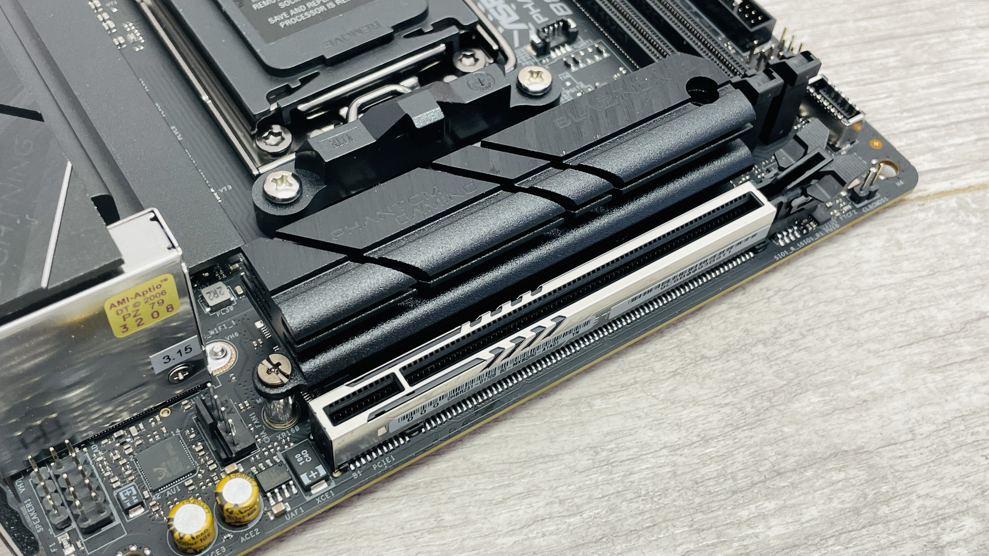 ASRock Phantom Gaming B850I Lightning Wi-Fi motherboard on a desk.
