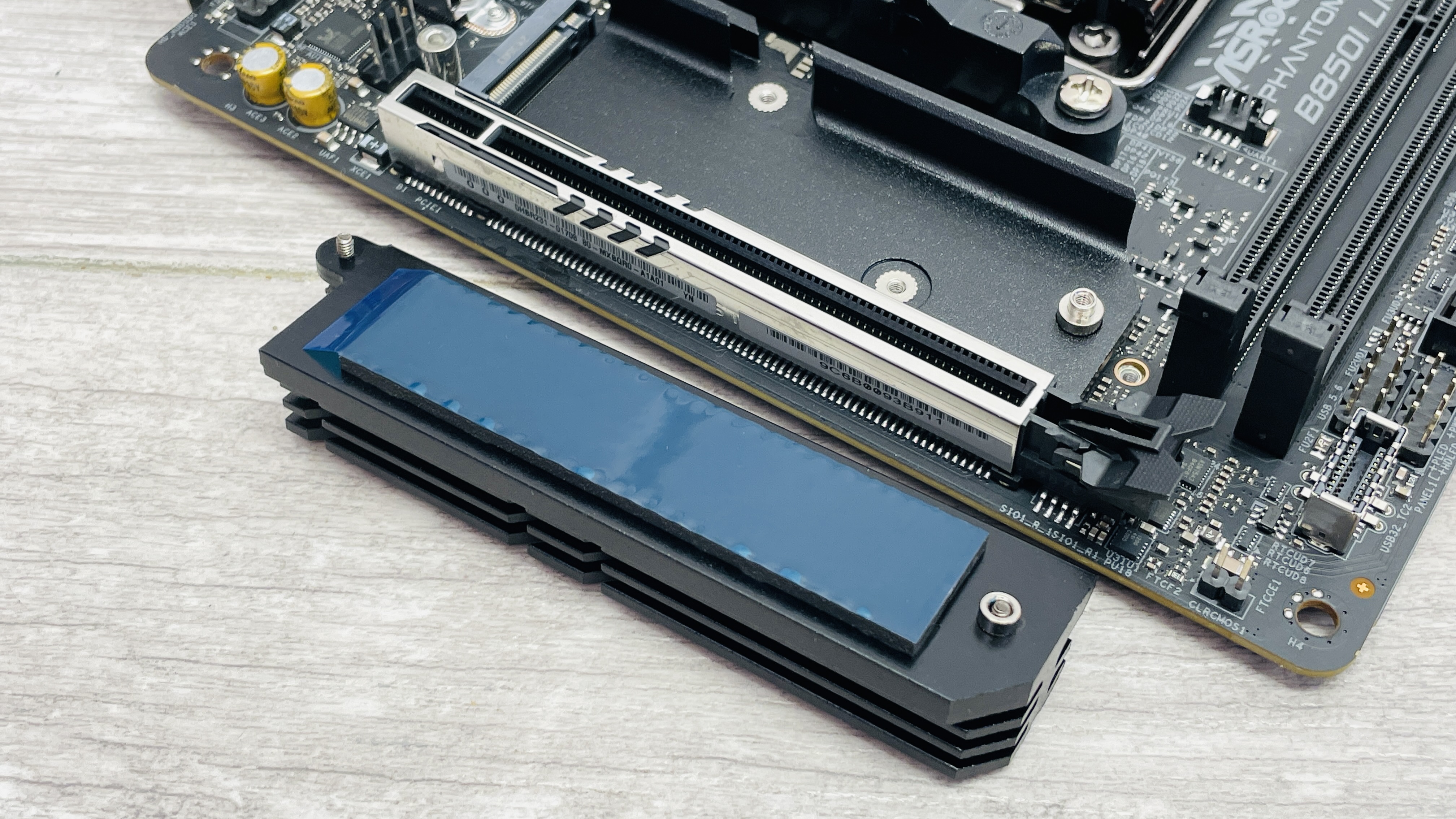 ASRock Phantom Gaming B850I Lightning Wi-Fi motherboard on a desk.