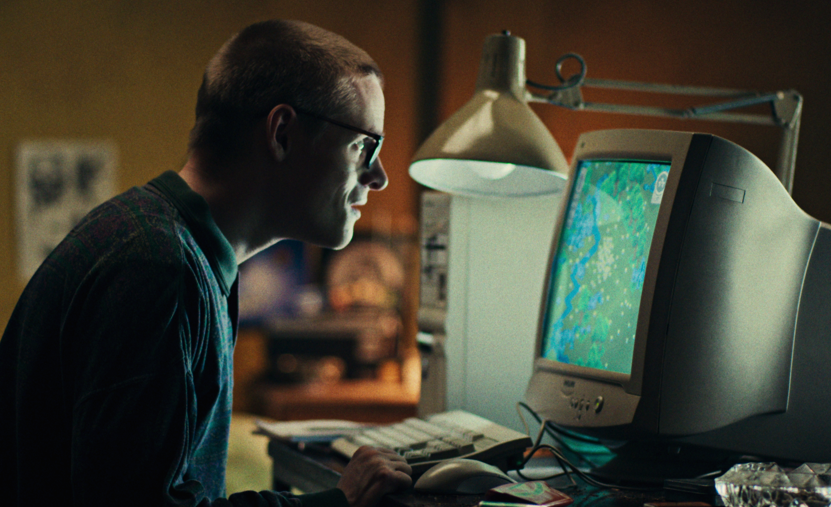 A man looking at a computer in the 1990s