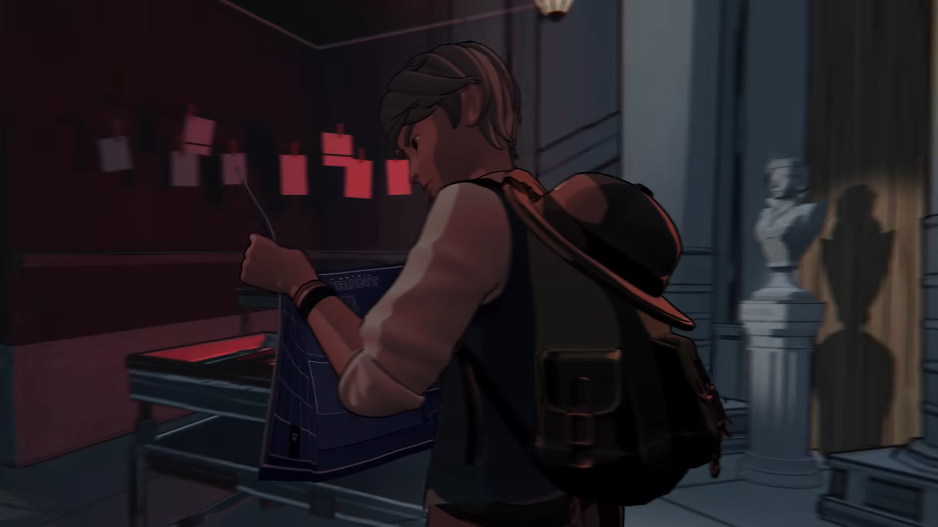 An image of Simon, the protagonist of Blue Prince standing in a room lit with red light and he’s holding a blue print as he examines it closely. An image of Simon, the protagonist of Blue Prince standing in a room lit with red light and he’s holding a blue print as he examines it closely.