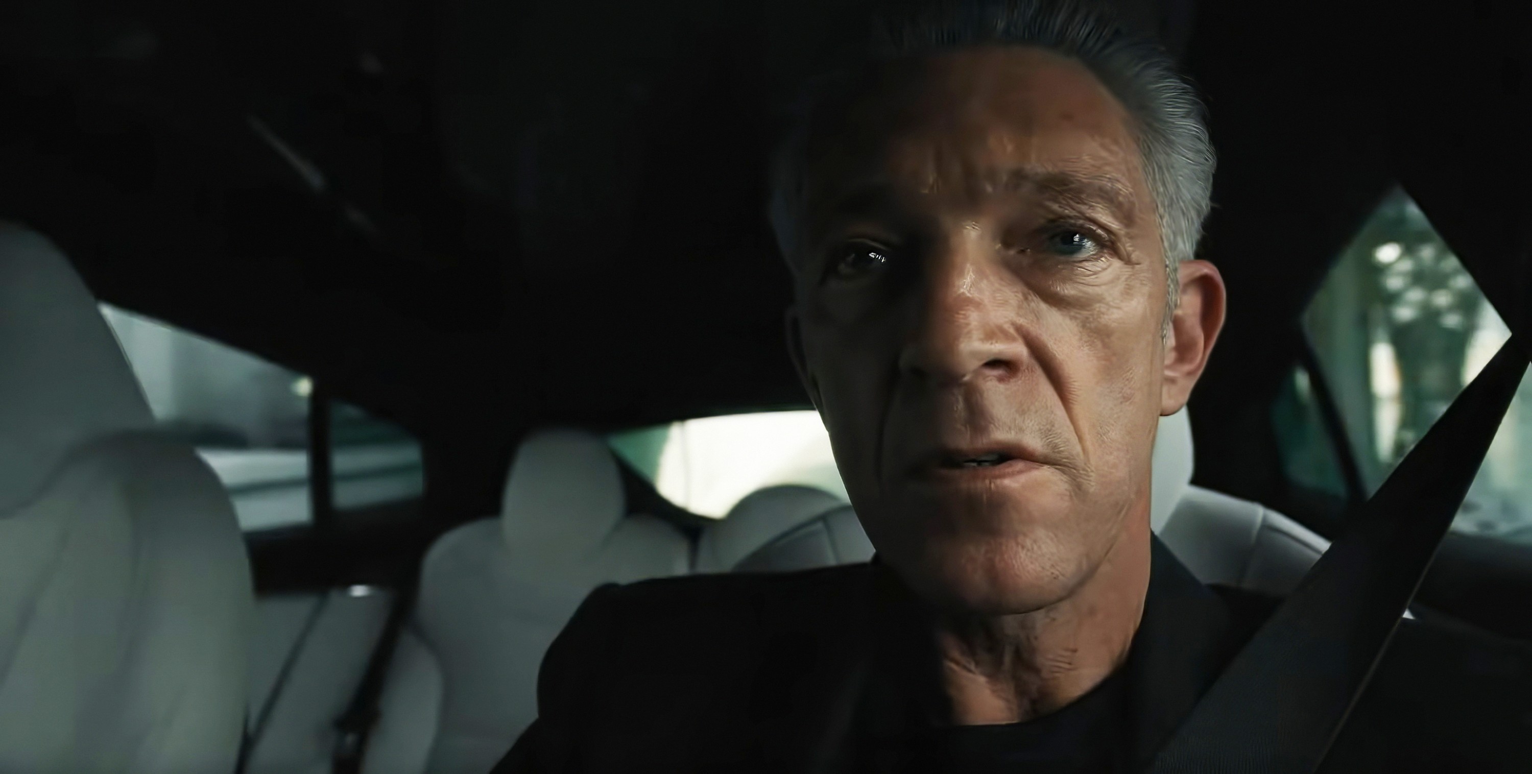 Karsh (Vincent Cassel) in close-up in his car looking pissed in a still from The Shrouds