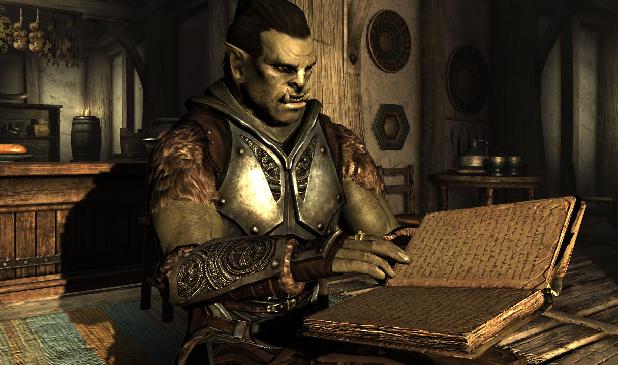 An orc reading a book in The Elder Scrolls V: Skyrim.