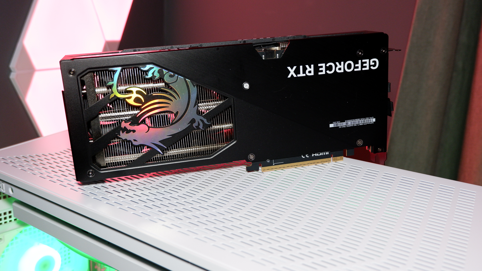 An MSI RTX 5060 Ti on top of a PC case and with the rear backplate removed.