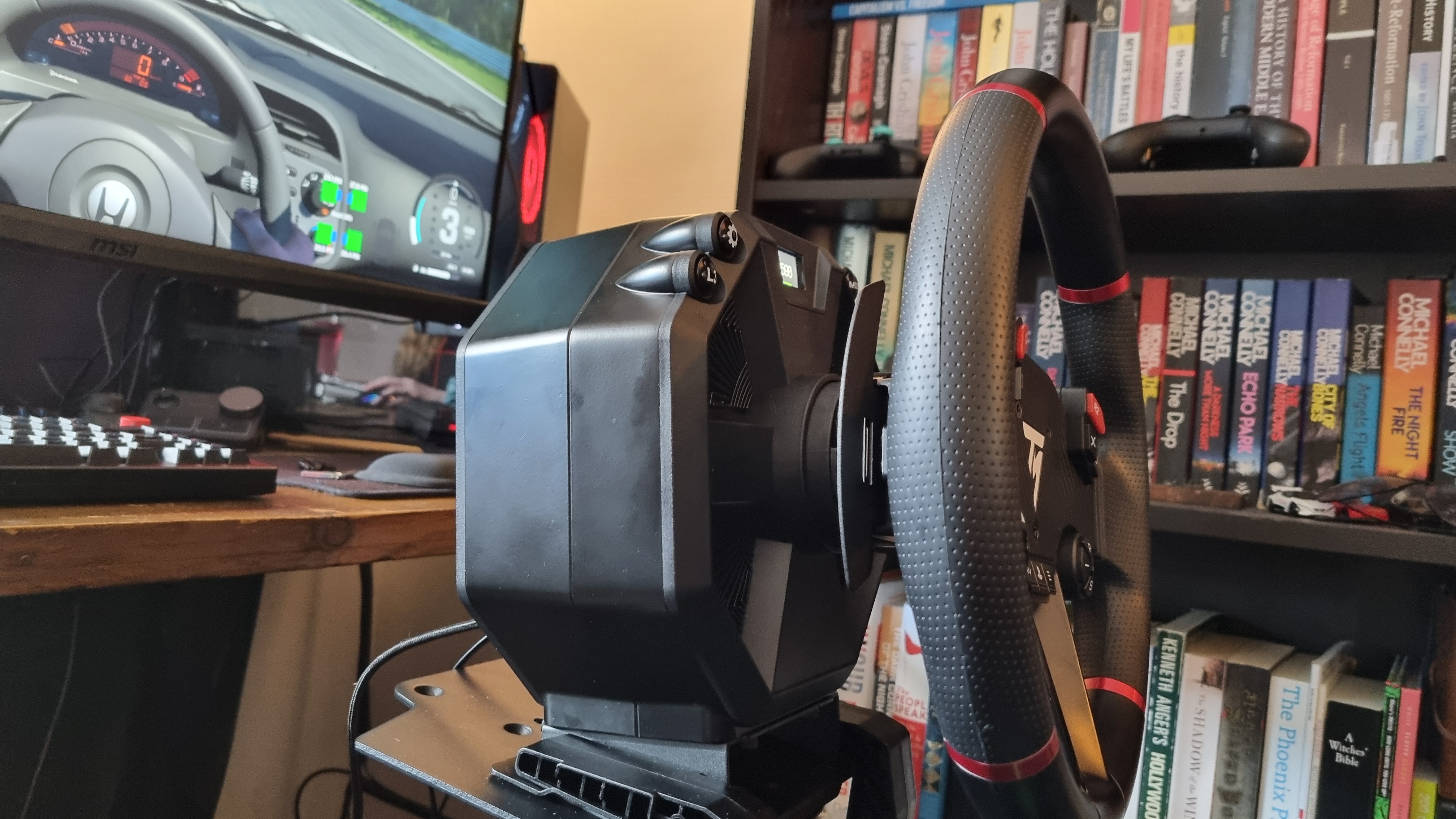 A profile shot of the Thrustmaster T598 attached to a sim rig