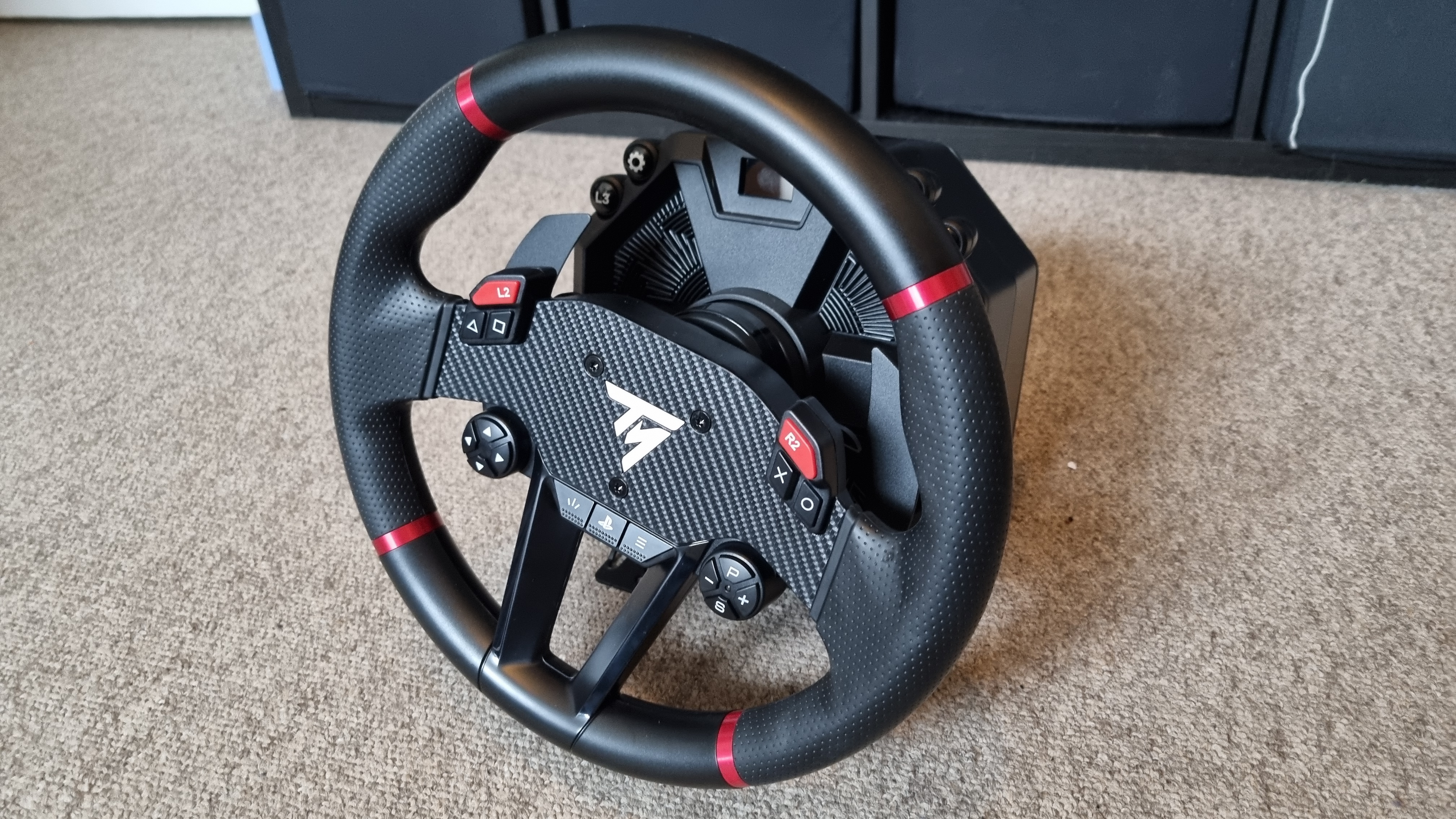 The Thrustmaster T598 wheel and pedal set, show from various angles on carpet