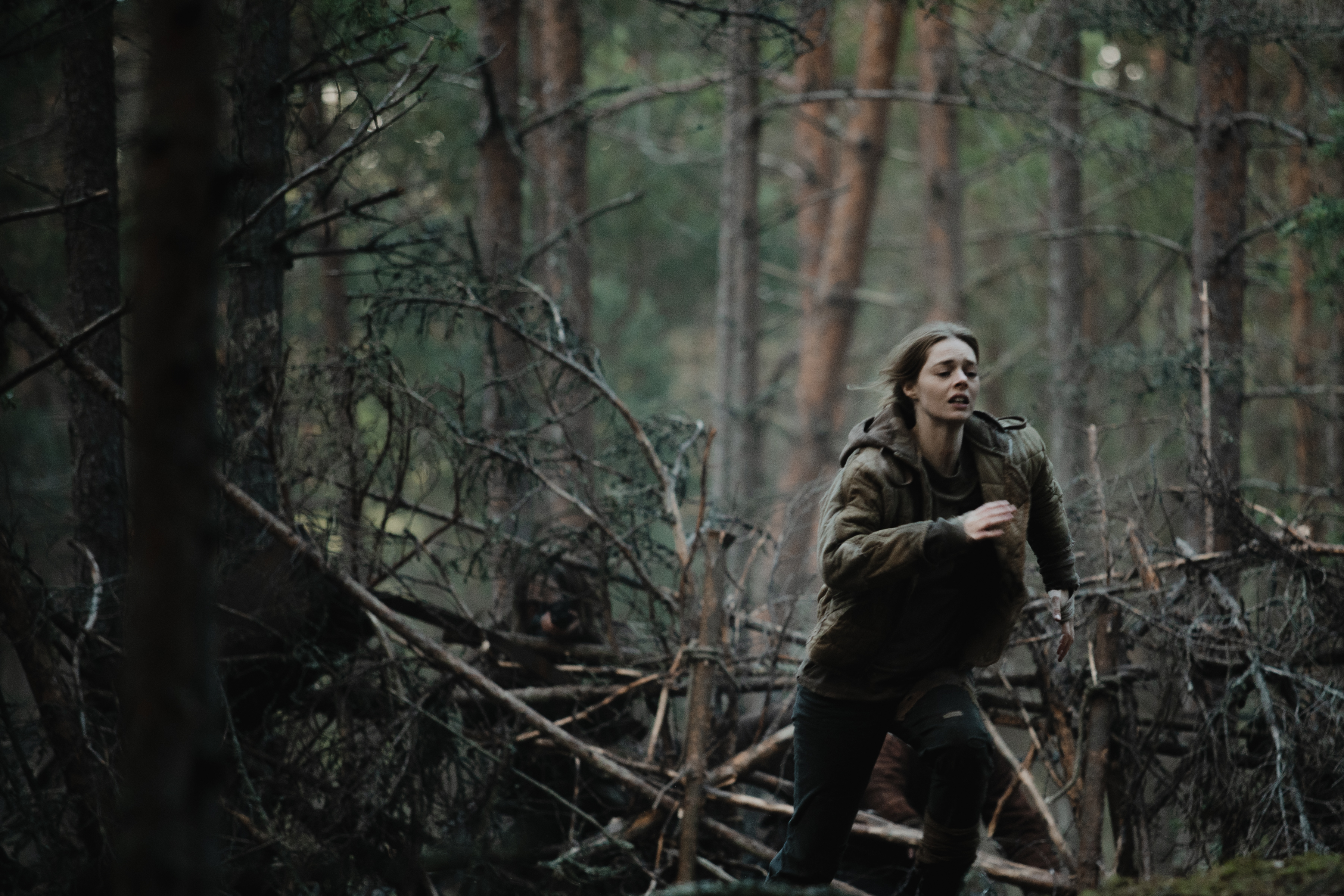 Samara Weaving in Azrael runs through the woods 