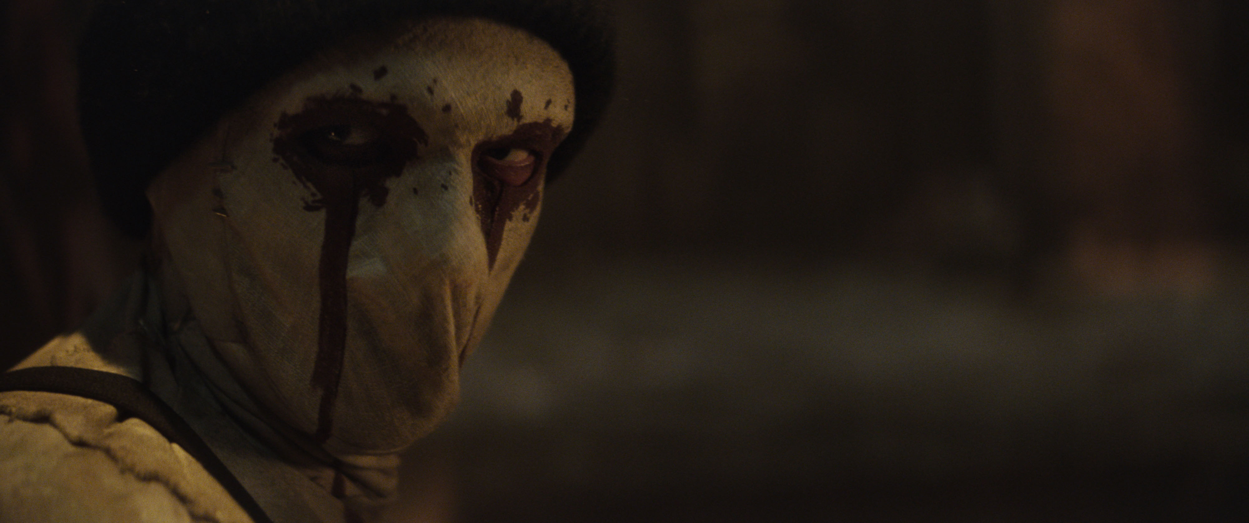 Muse, wearing a white mask with red eye accents, in Daredevil: Born Again