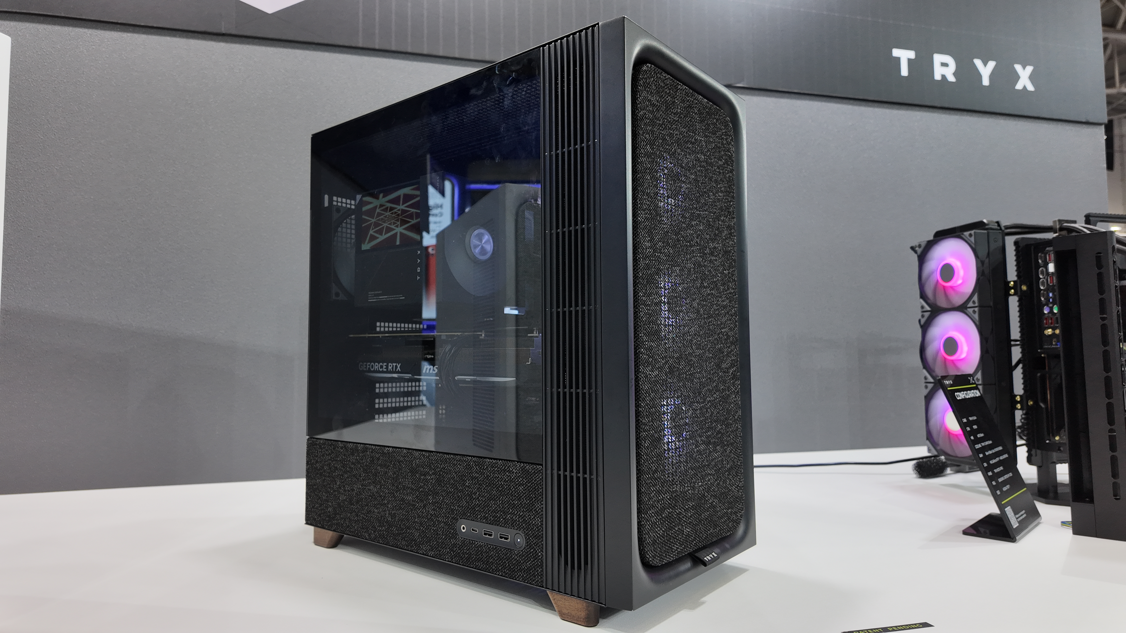Tryx's Computex 2025 booth, showcasing various new PC cases and coolers.
