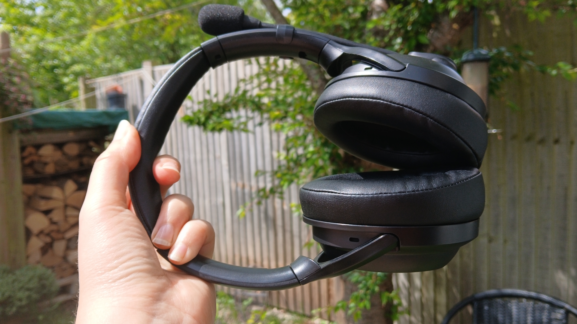An AceZone A-Blaze wireless gaming headset held up outside.