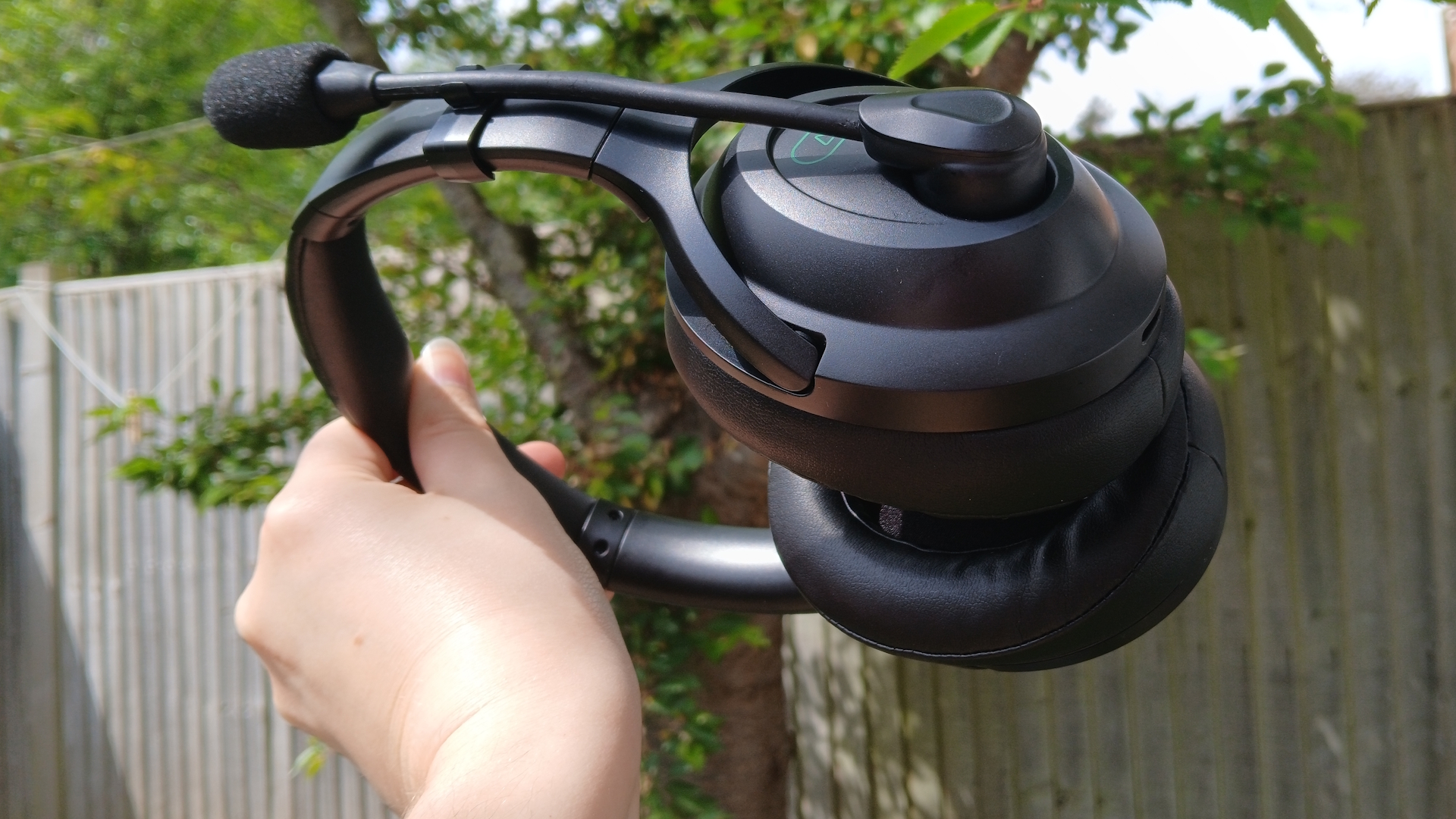 An AceZone A-Blaze wireless gaming headset held up outside.